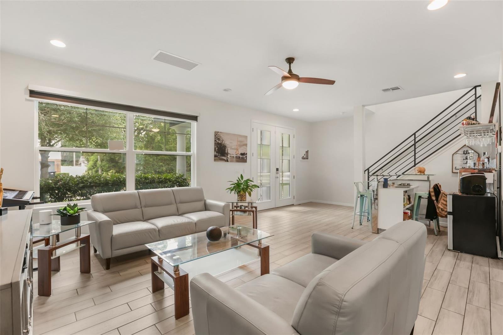 Inviting living room with abundant natural light, high ceilings, and an open layout that creates a bright and welcoming atmosphere.