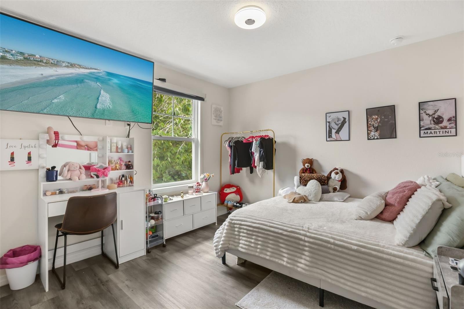Bright secondary bedroom featuring abundant natural light, a spacious layout.