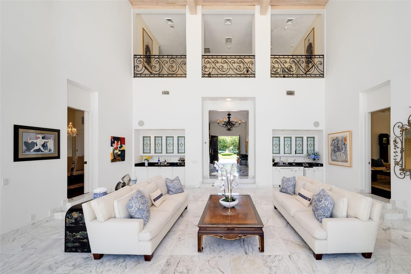 The two wet bars in the gathering room for entertaining, the foyer and the formal dining and formal living rooms flow into the main gathering room for