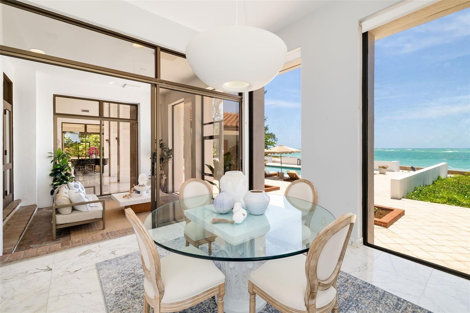 Here you can see the relaxing flow of the covered and screened terrace off the eat-in kitchen.  It also flows through from the formal dining room and 