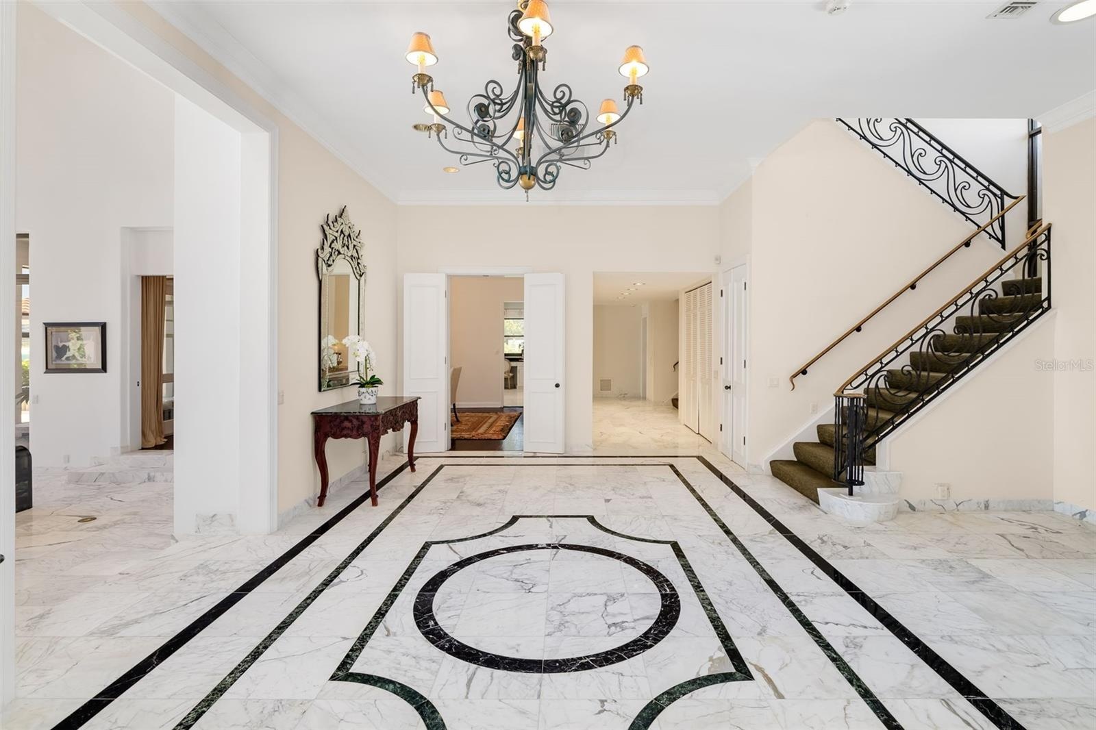 One of the 2-Staircases, the main entrance to the formal dining room off the foyer and the hallway down to the billiards room, Kitchen and downstairs 