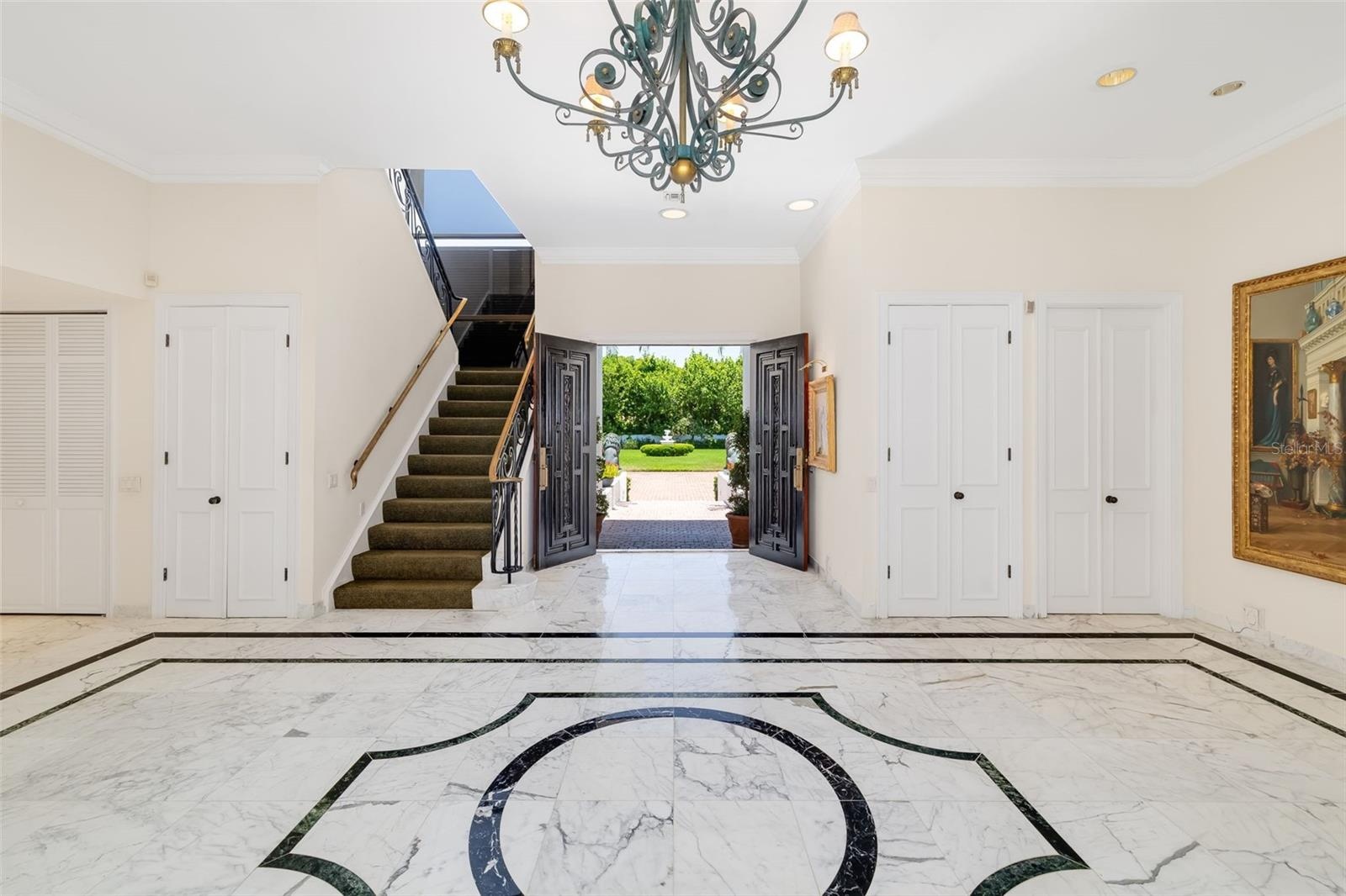 The front double doors at the entry are flanked by multiple closets.