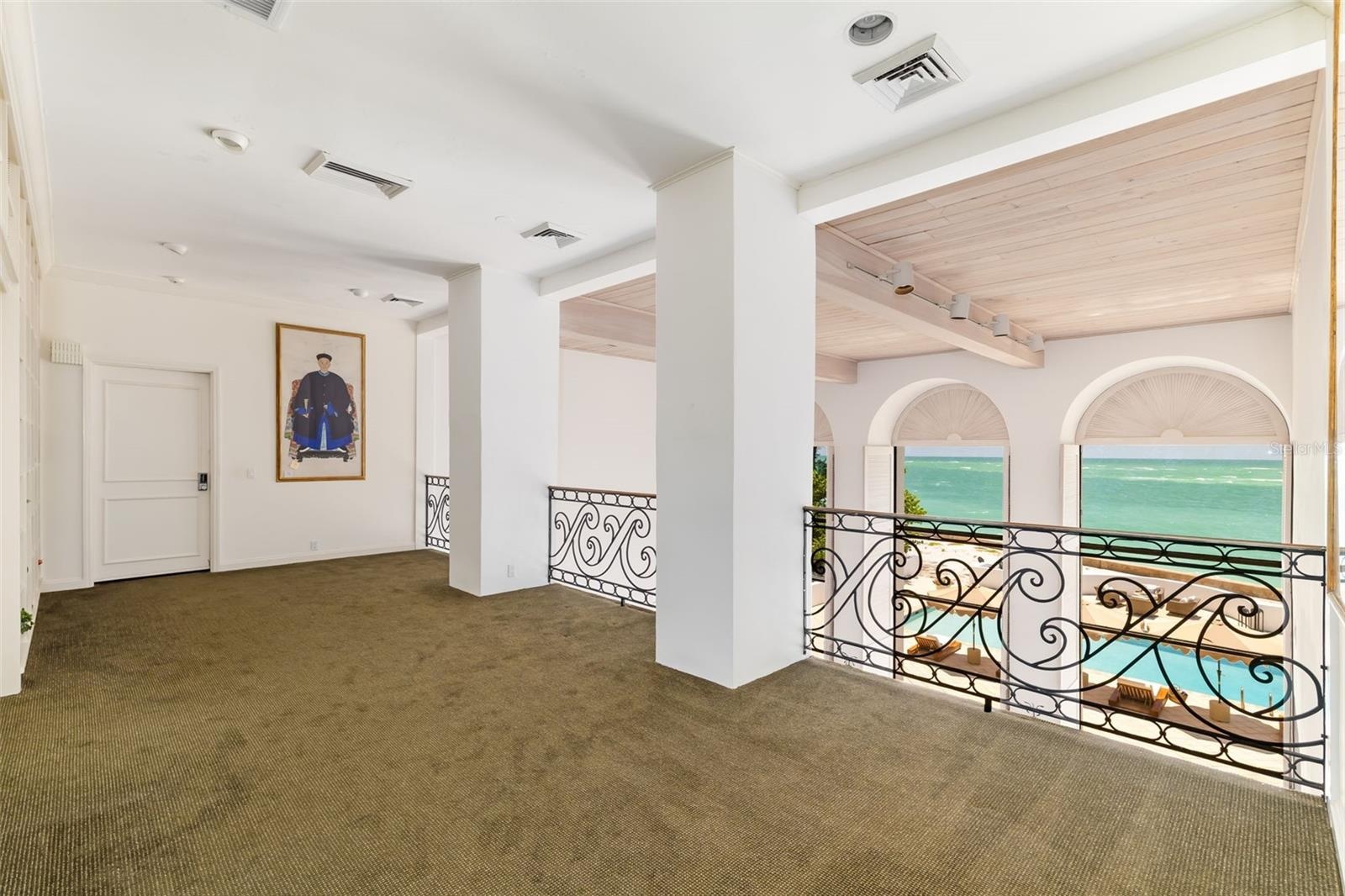 Primary Bedroom with ensuite and walk-in closets behind closed door, walk out terraces overlooking ocean. There is great wall space throughout the hom