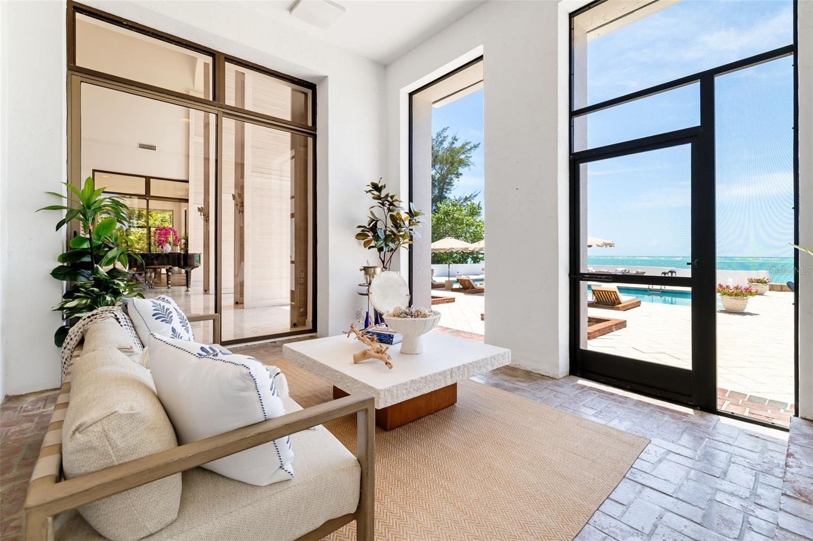 Covered and screened lower terrace flowing out of 3 main rooms to the stunning views... you can get here from the gathering room, the formal dining ro