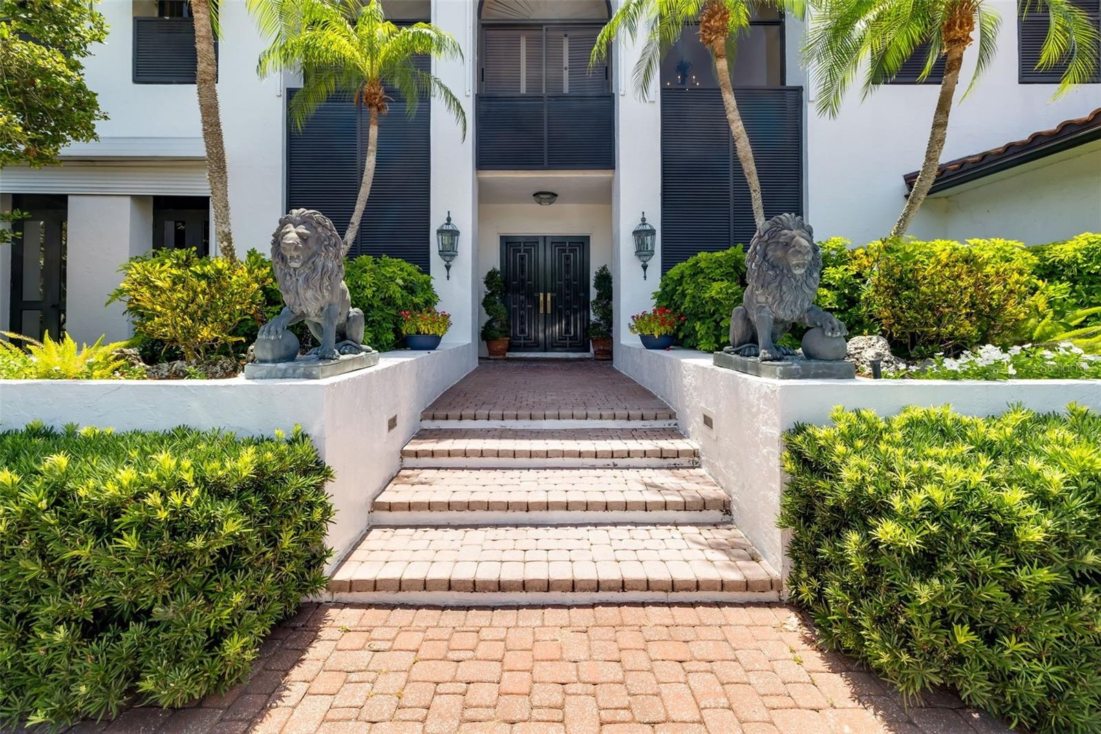 A stately greeting to all who arrive surrounded by natural Florida landscaping, lush and tropical