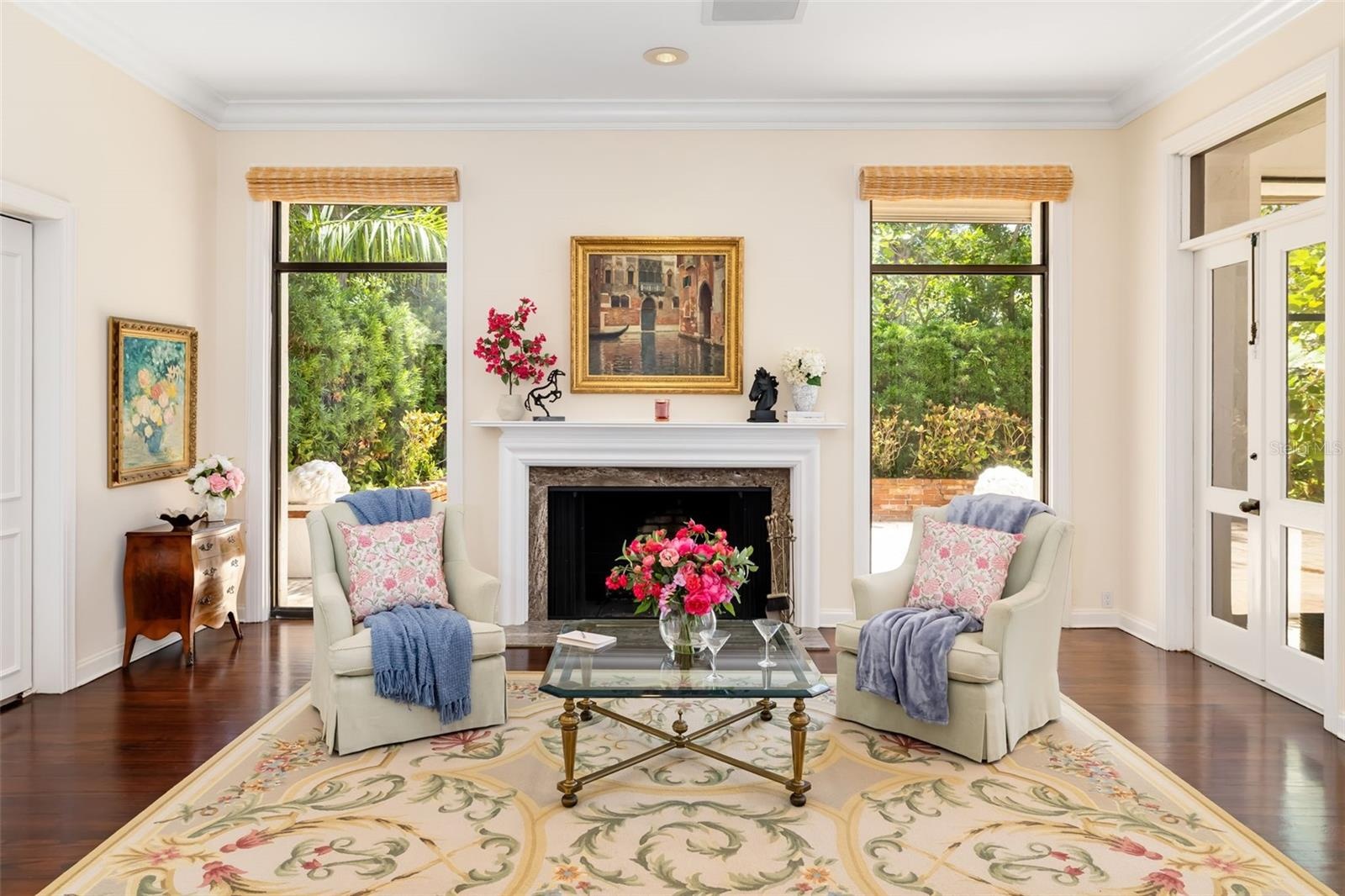 The wood burning fireplace and outside the windows you can see the lovely brick enclosed side patio that could be utilized for many creative purposes 