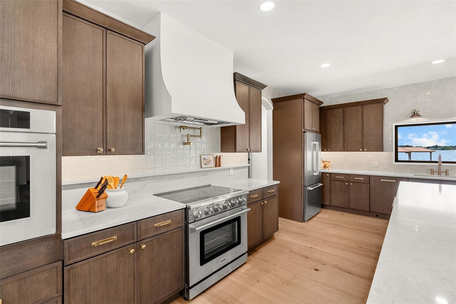 SHOWING ALL OF THE CABINET SPACE AND STORAGE CONVENIENTLY LOCATED IN THE KITCHEN