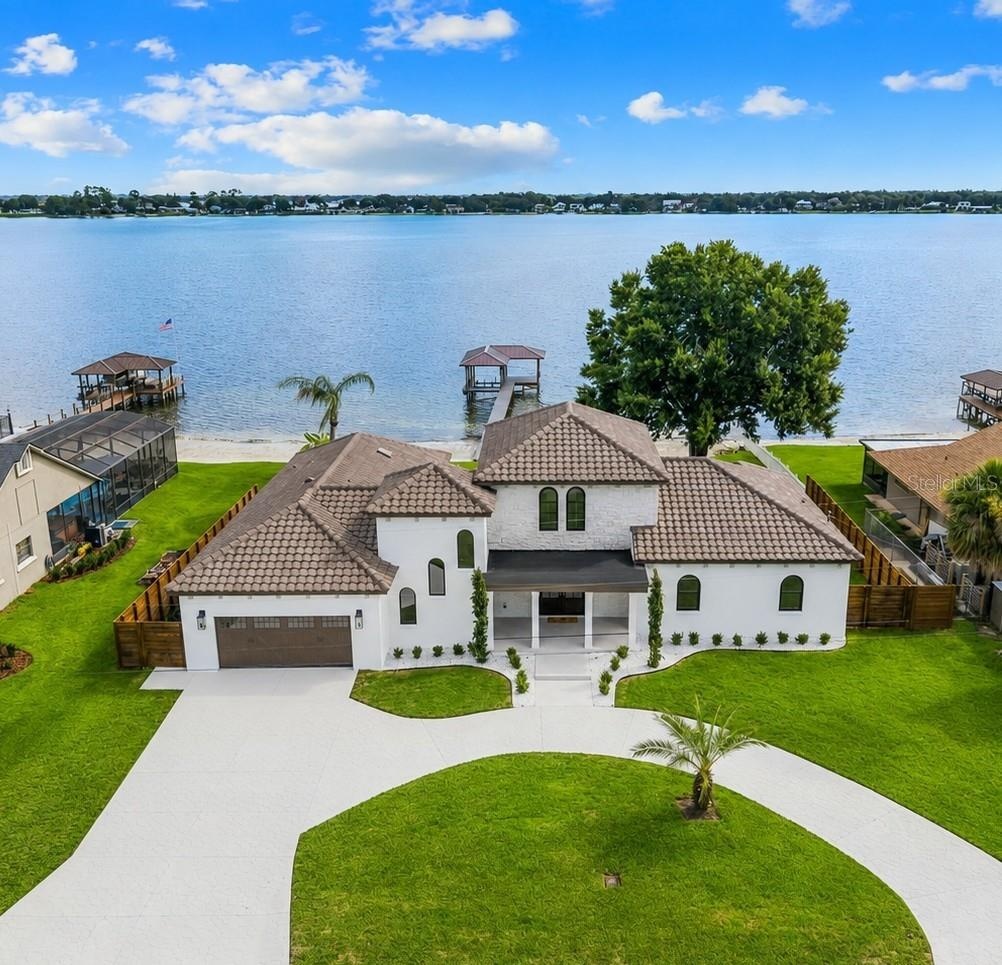 SWEEPING AERIAL VIEW HIGHLIGHTING CUSTOM LANDSCAPING AND LAKE CONWAY
