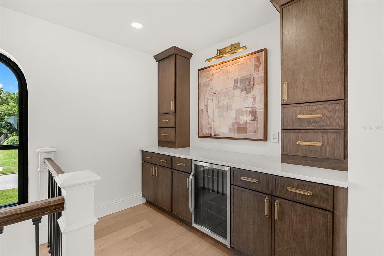 CUSTOM LOFT RETREAT WITH BUILT-IN STORAGE AND BEVERAGE FRIDGE