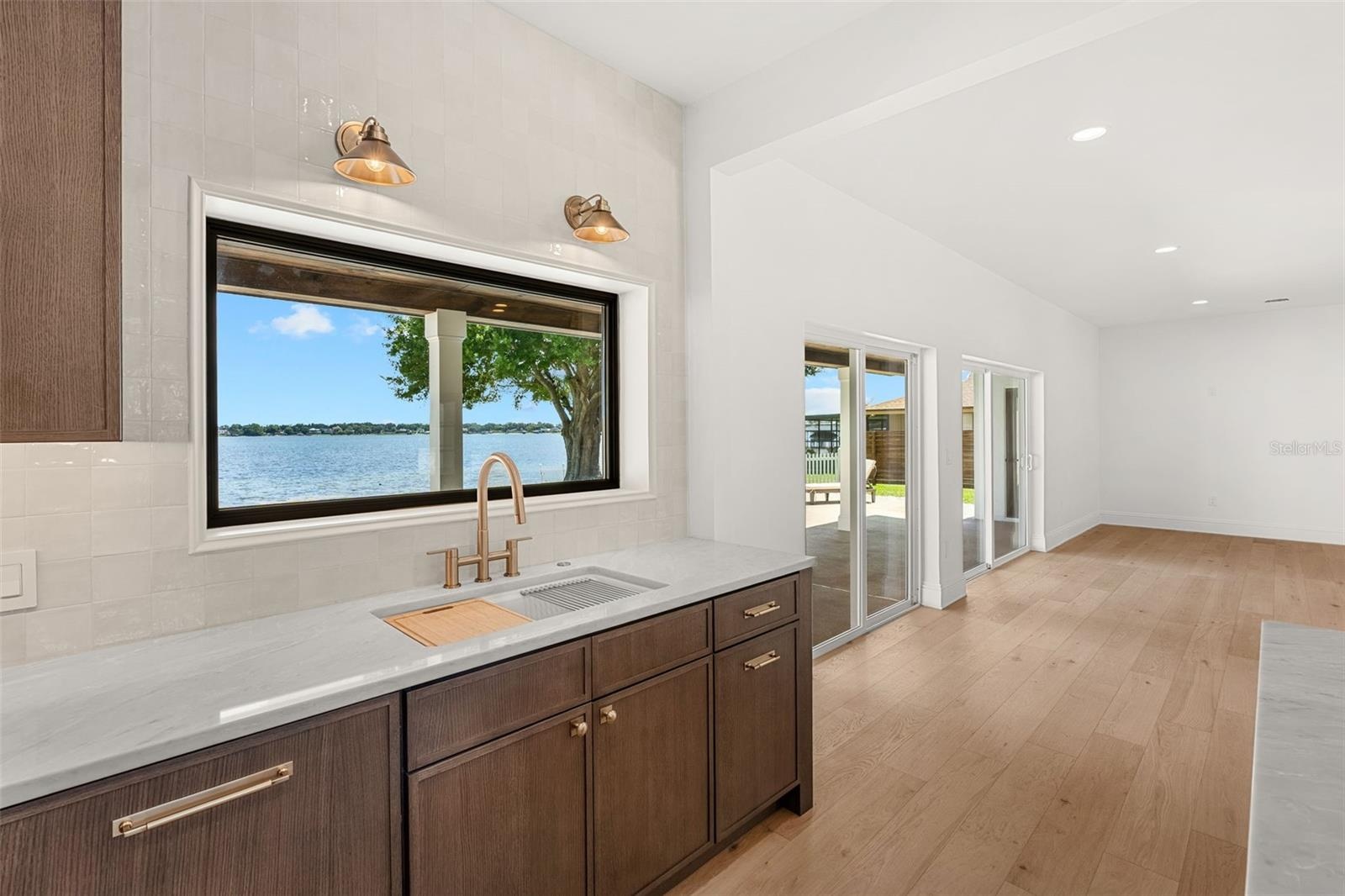 ENJOY PANORAMIC POOL AND LAKE VIEWS FROM THE KITCHEN SINK