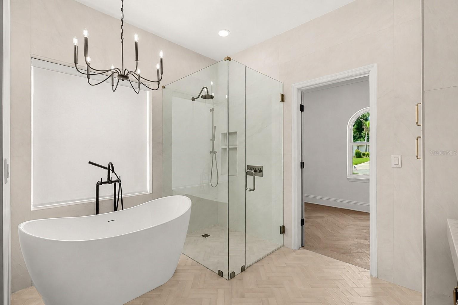 PRIMARY SPA RETREAT WITH SEPARATE SOAKING TUB AND GLASS-ENCLOSED SHOWER