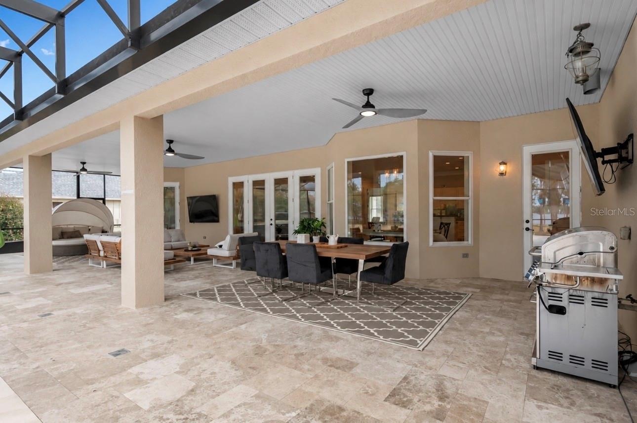 Oversized covered lanai designed for year-round outdoor living, dining and entertaining with peaceful water front views.