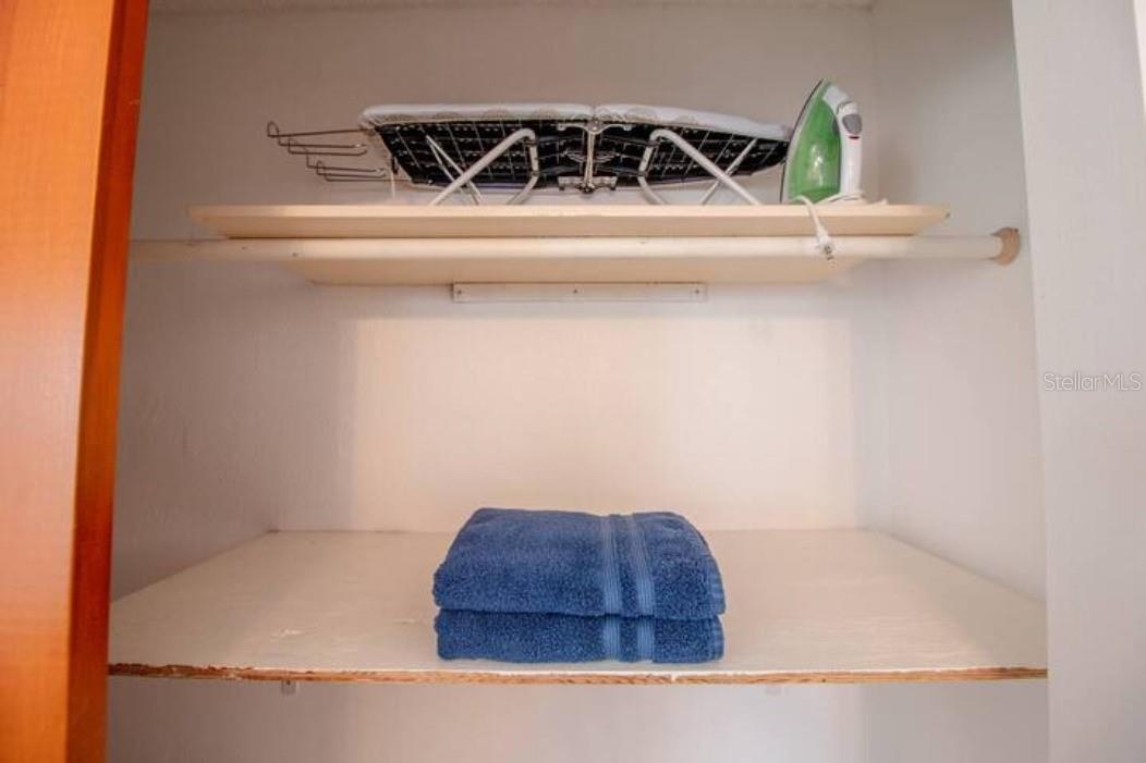 Closet, ironing board, iron, additional towels