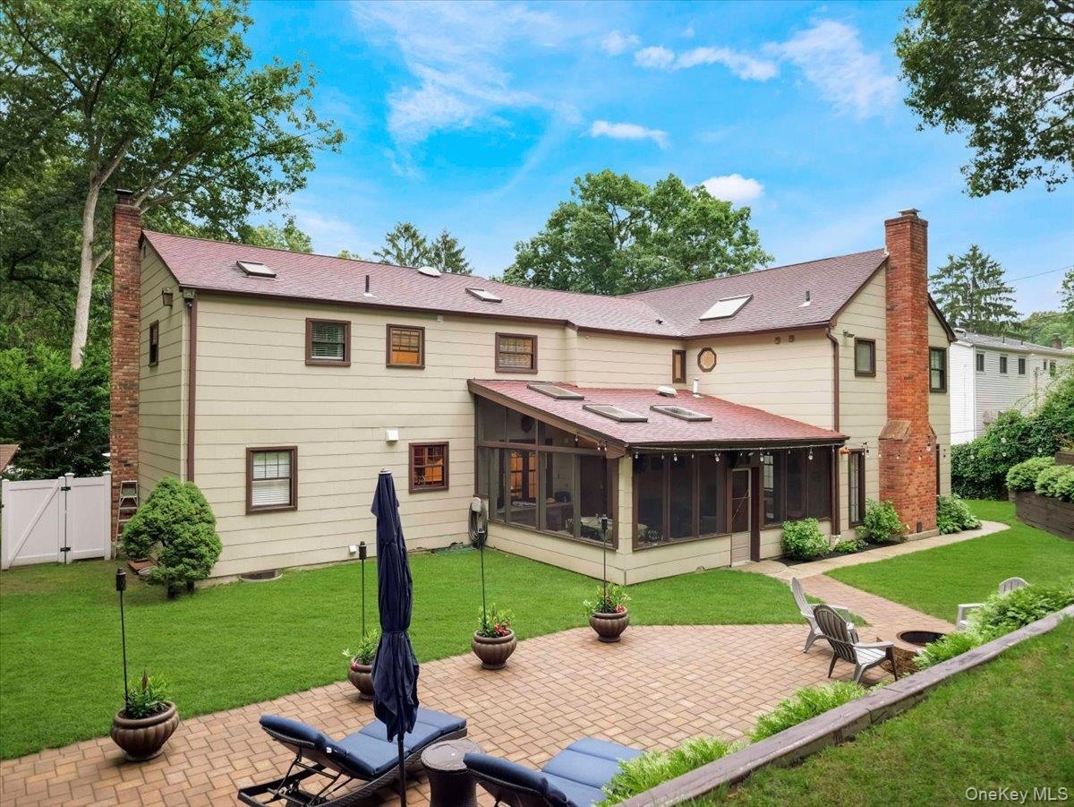 Expansive paver patio with a built-in fire pit