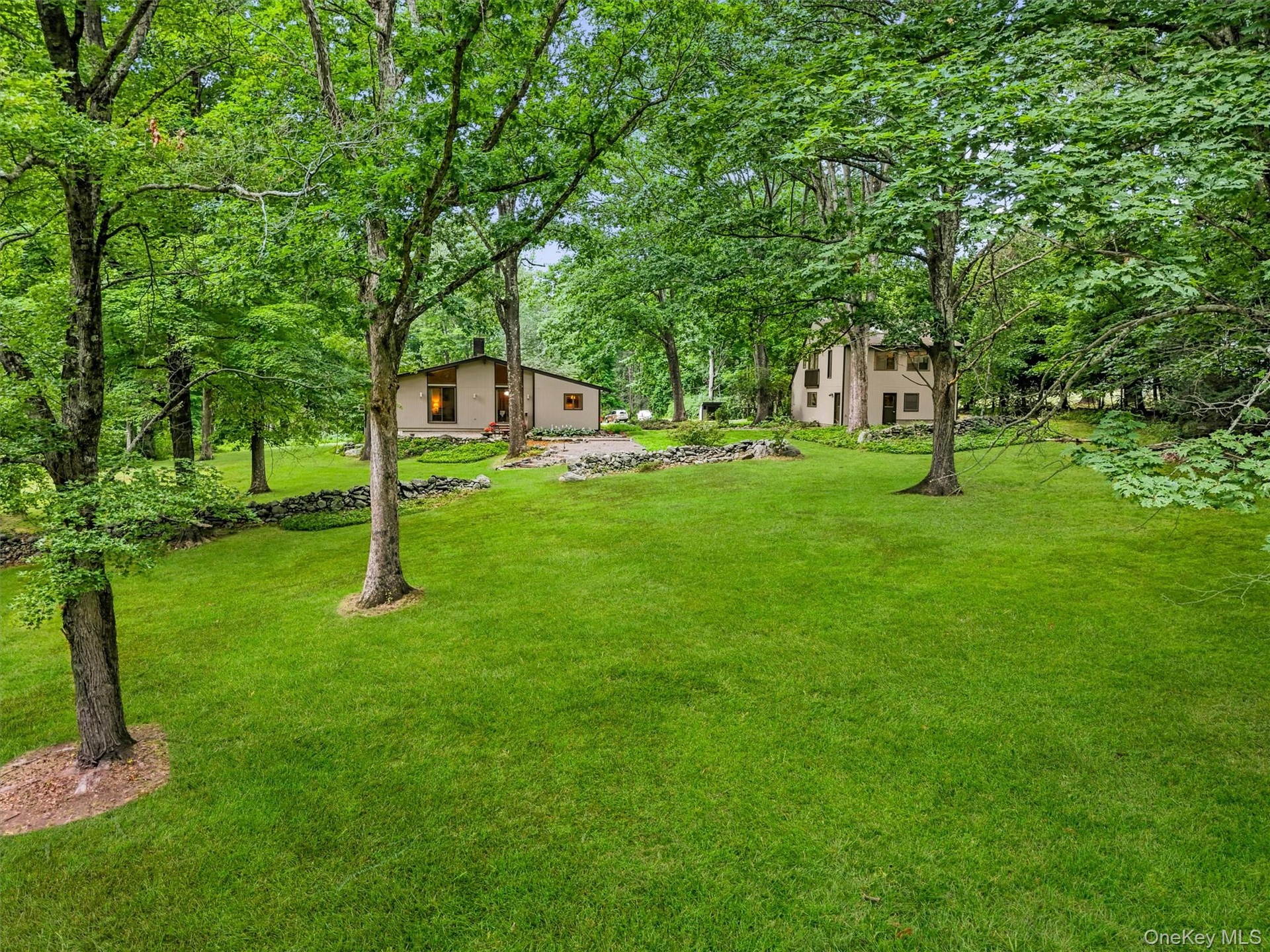 Expansive green lawn with mature trees