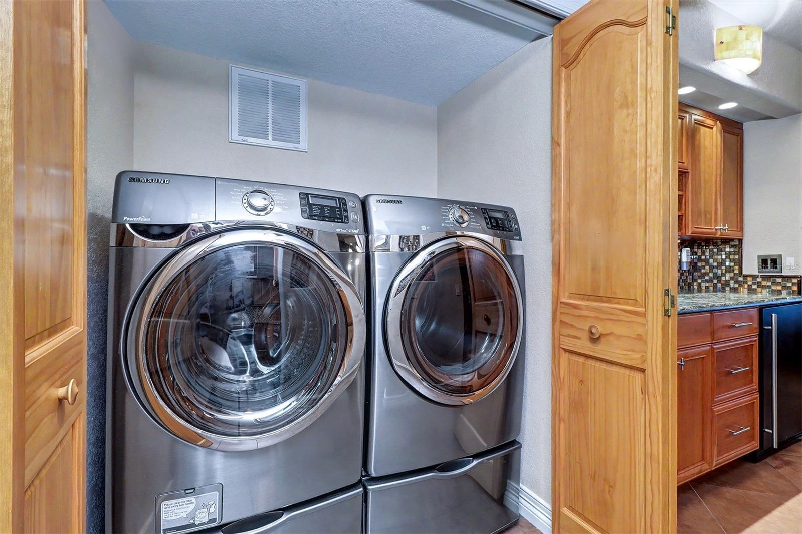 Samsung front loading washer and dryer in interior Laundry Closet.