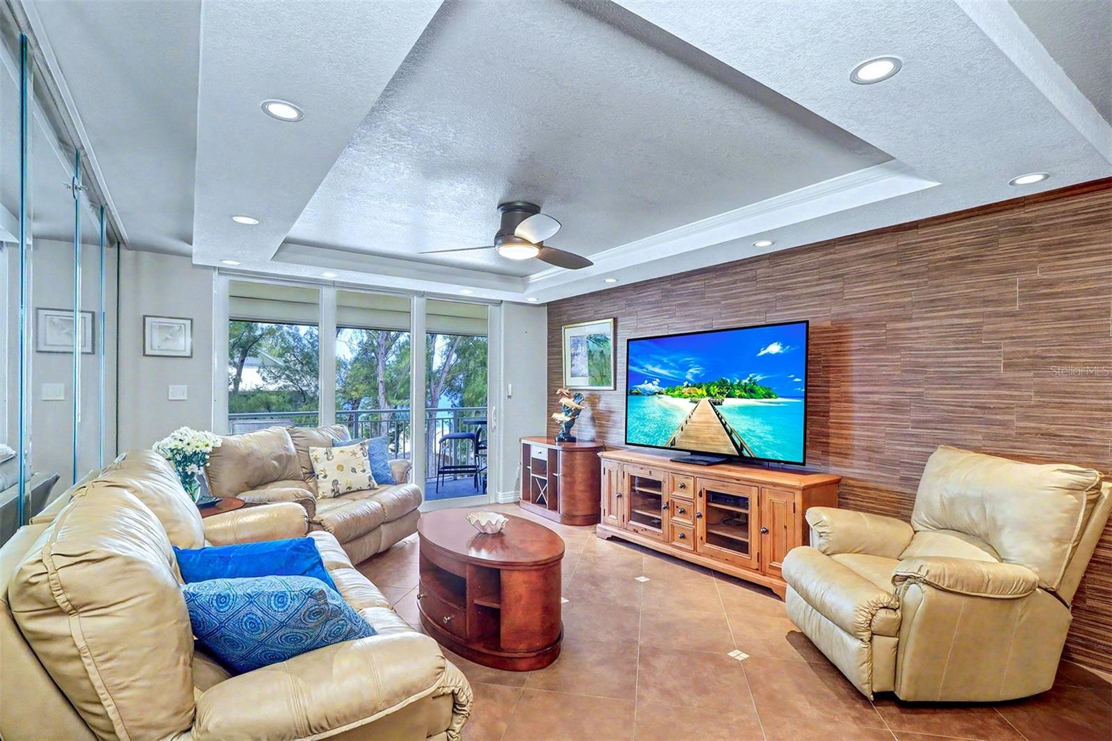 The living area is elevated by softly illuminated tray ceilings that accentuate the expansive Gulf and beach vistas.