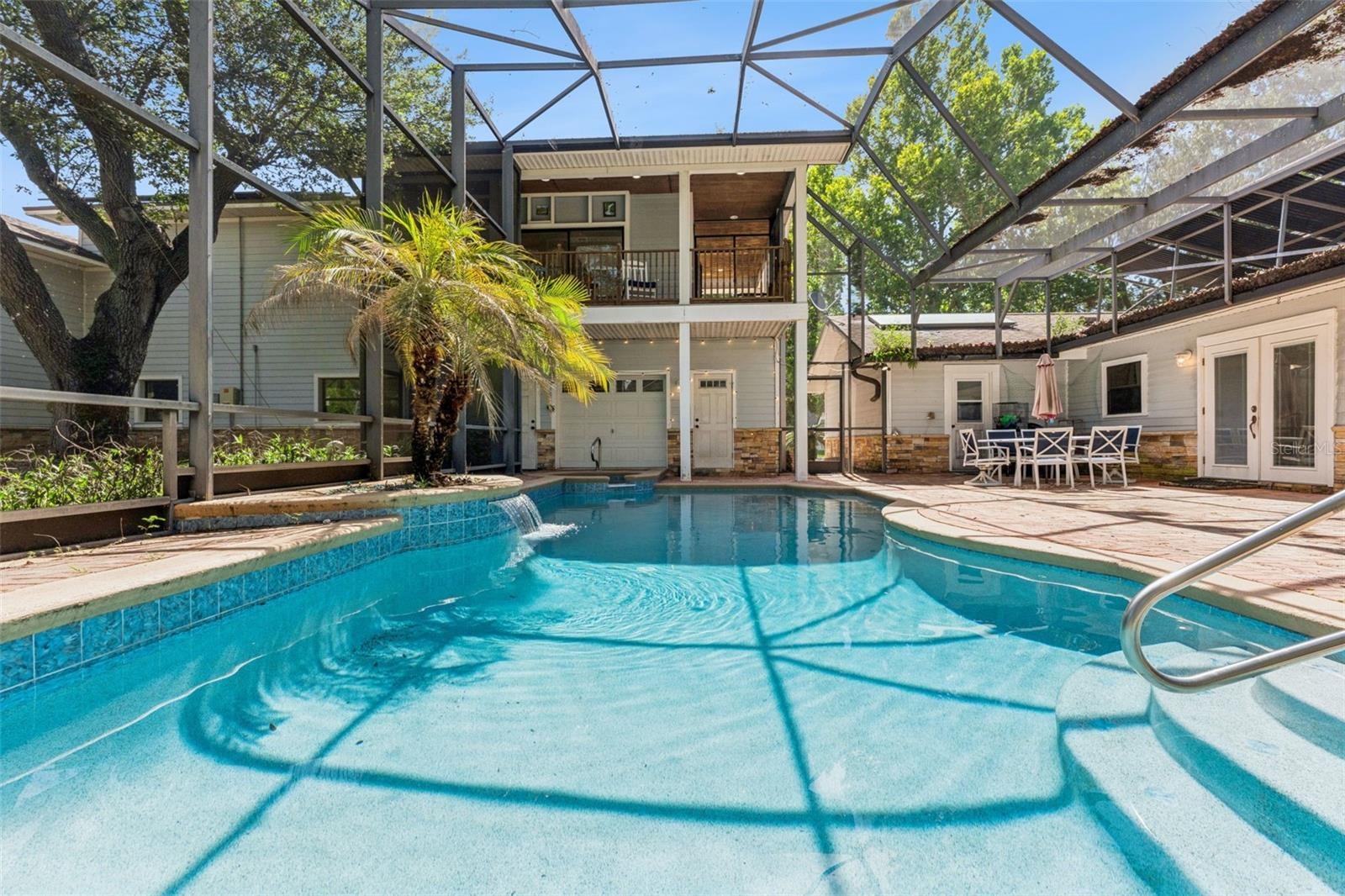 Pool and entrance to separate apartment overlooking pool area