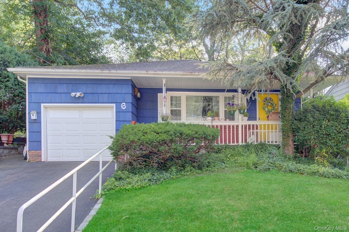 Blue siding exterior with a white garage door
