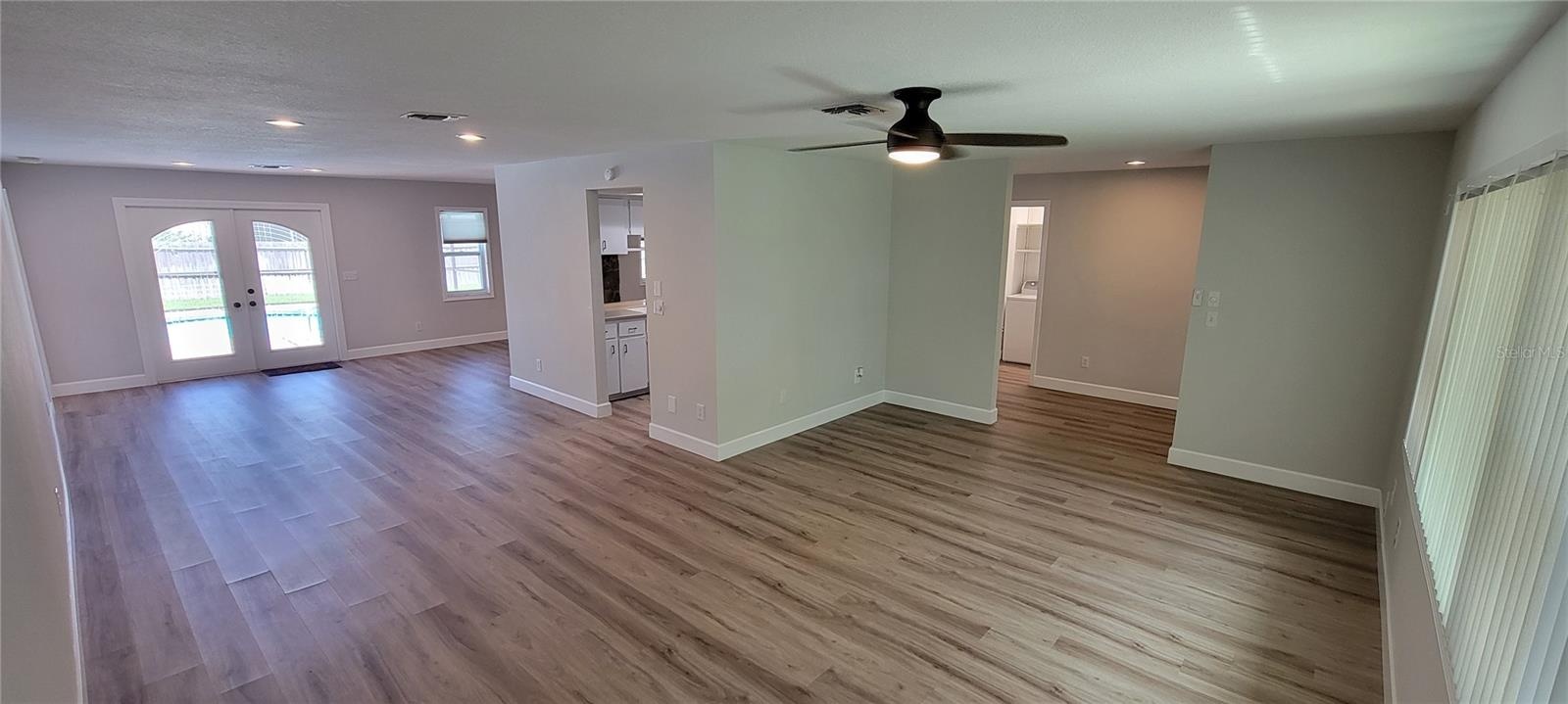 Front living room looking towards the dining area and doorway to the pool.