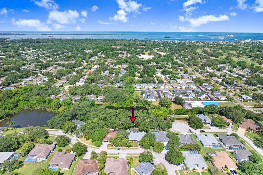 Drone view of property and neighborhood