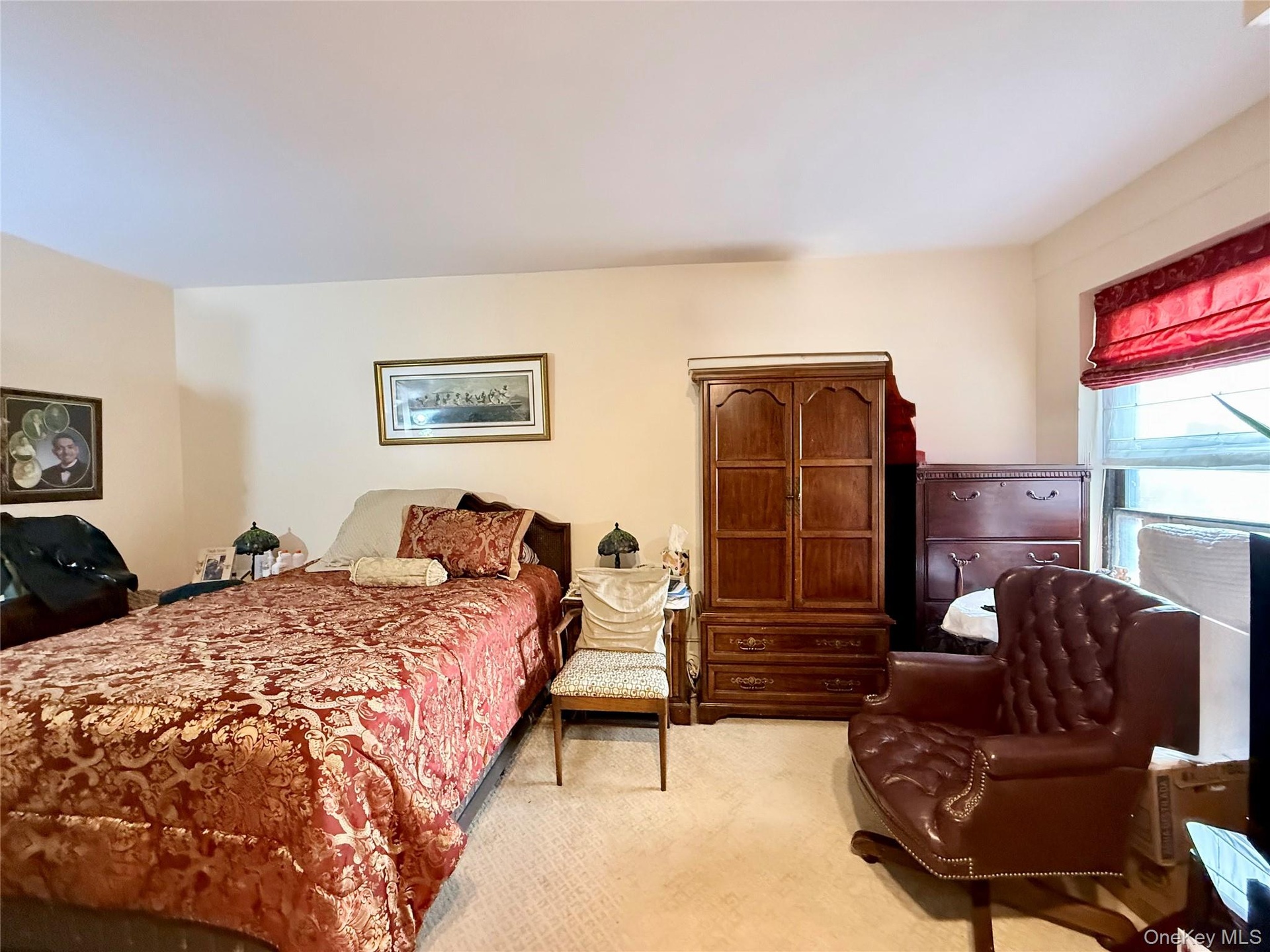 Large primary bedroom, carpeted. There are 2 closets and a large window, an extra closet in the hallway near this bedroom.