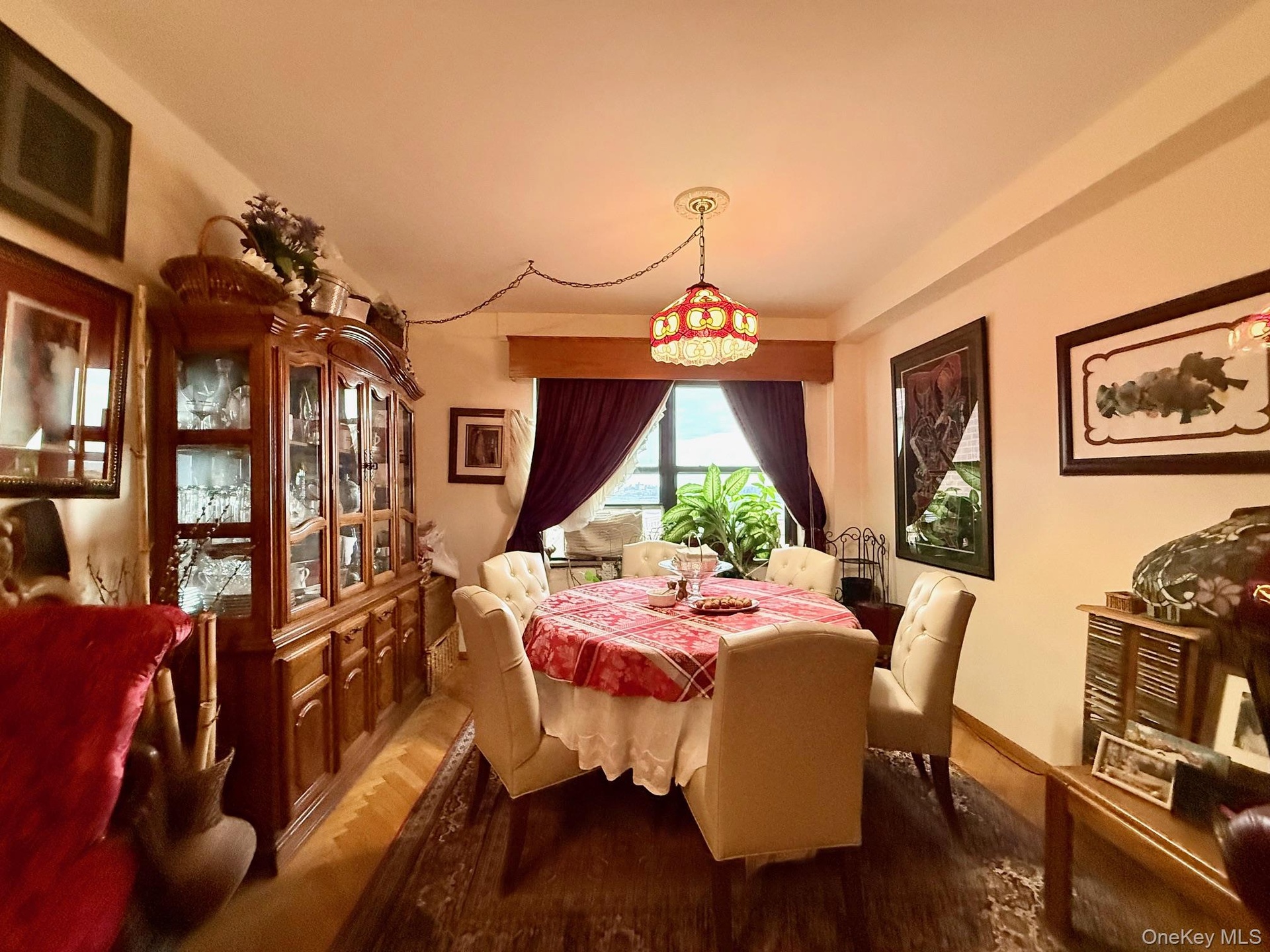 Open to the living room, double panel window, hardwood floors