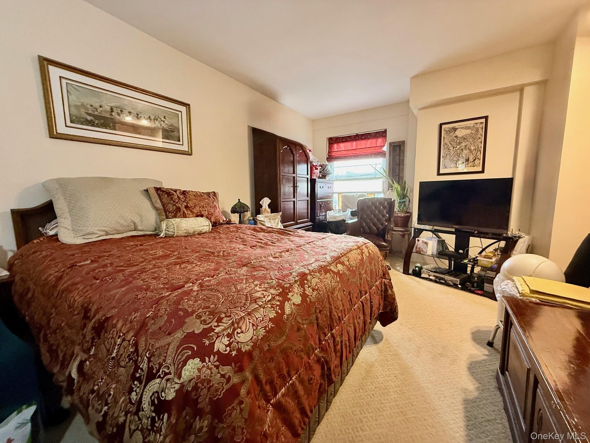 Large primary bedroom, carpeted. There are 2 closets and a large window, an extra closet in the hallway near this bedroom.