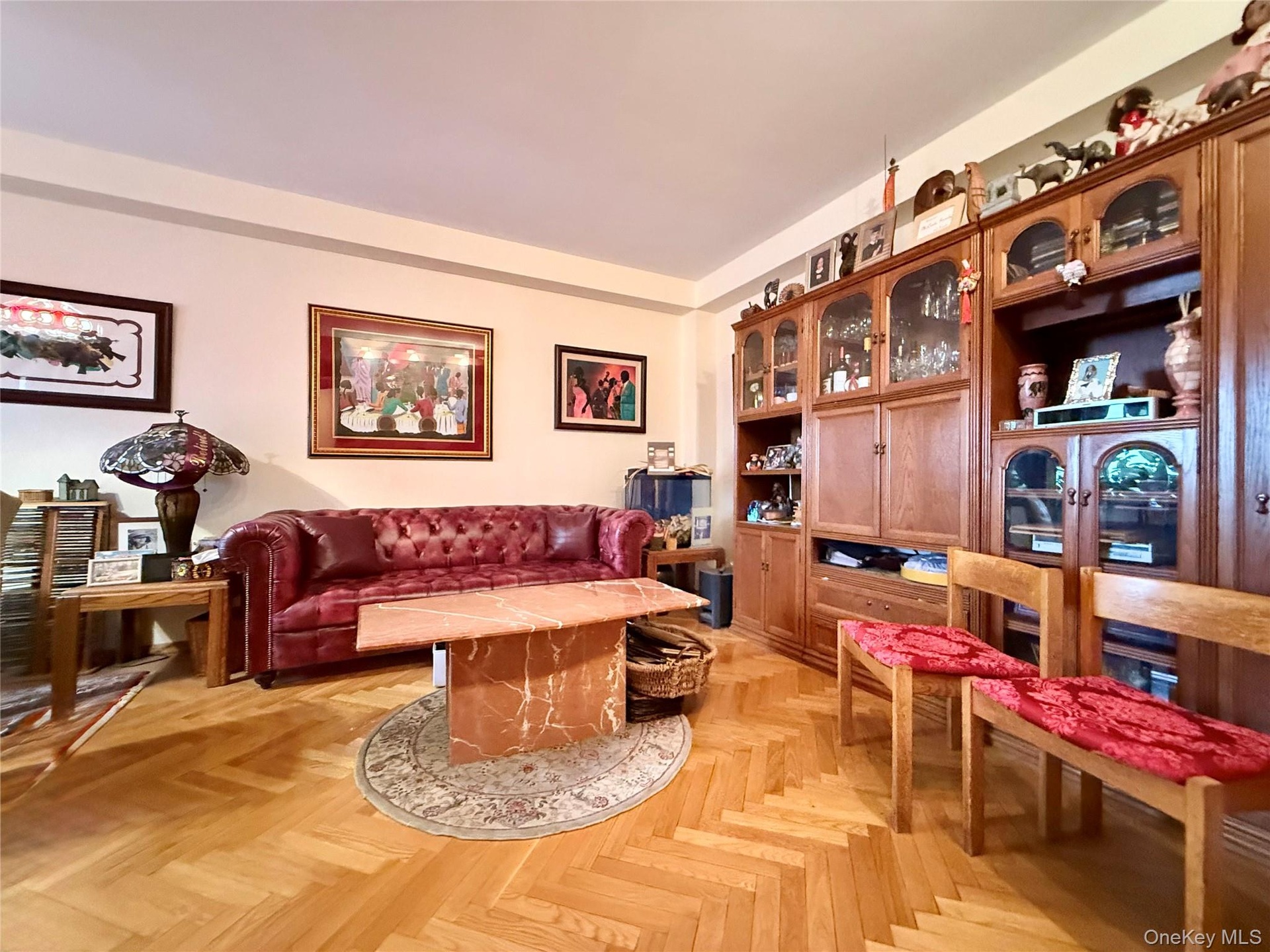 Elegant herringbone hardwood floors, open to the dining area that has a double panel window