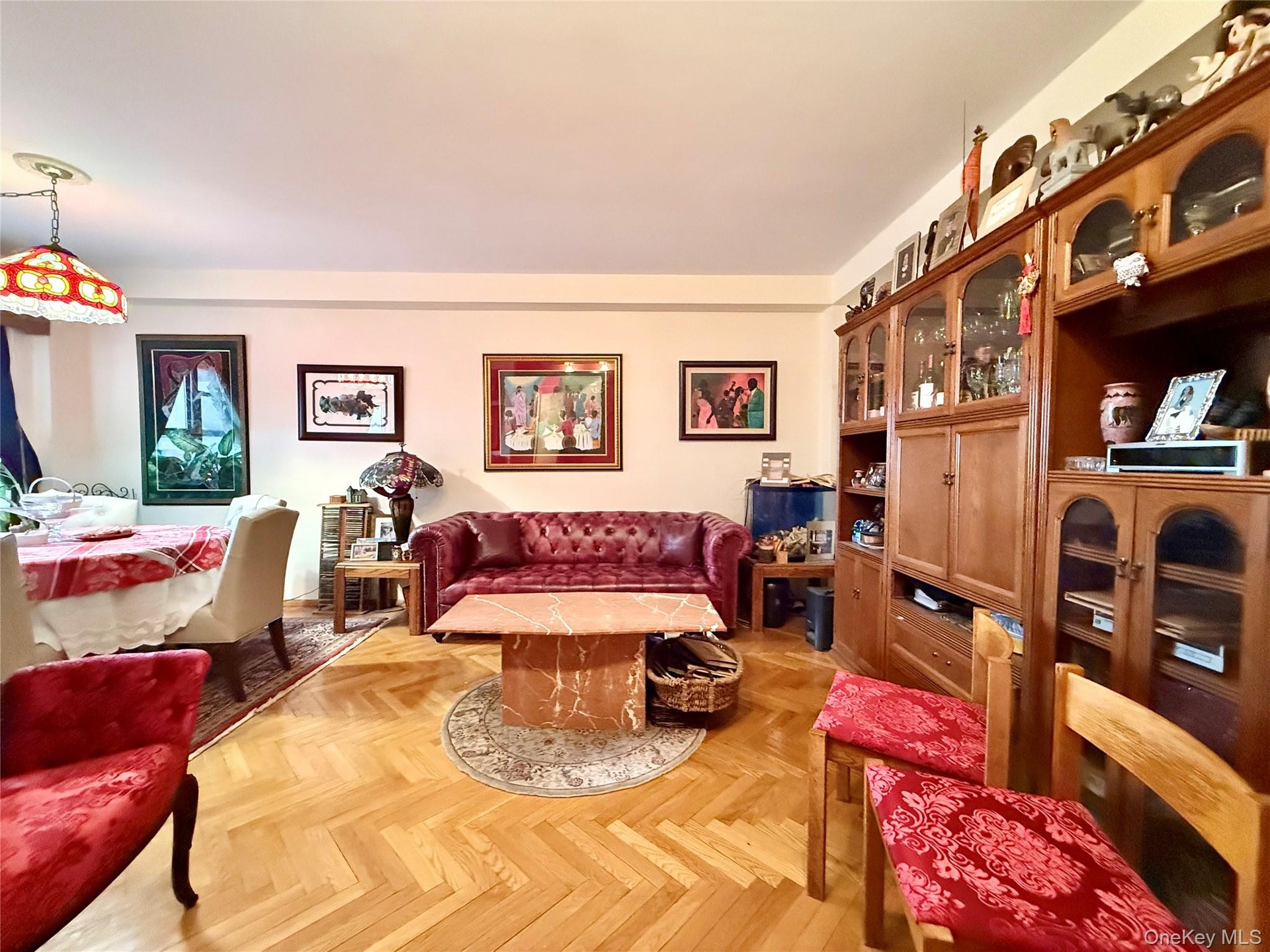 Elegant herringbone hardwood floors, open to the dining area that has a double panel window