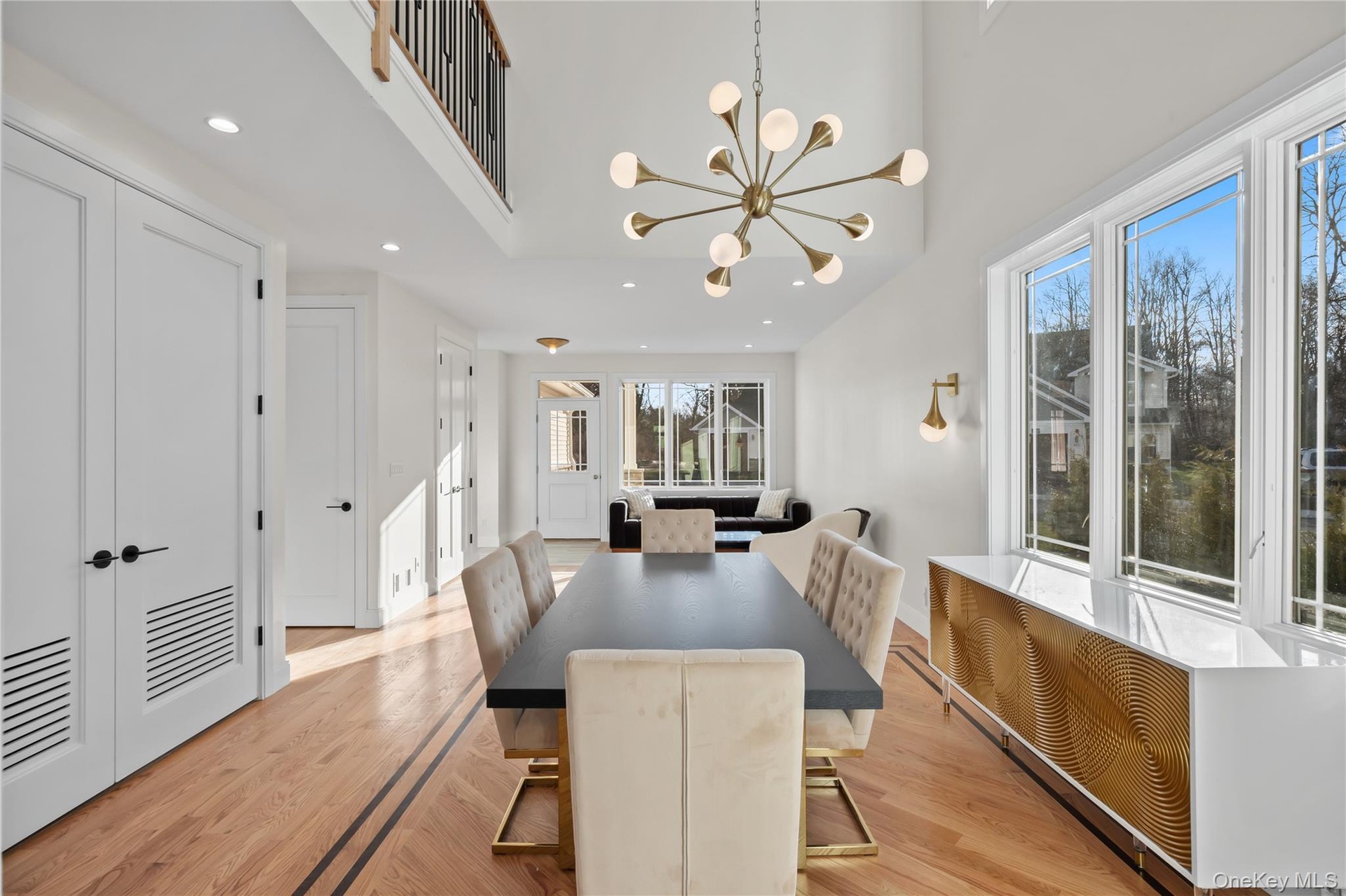 Dining space with recessed lighting, a chandelier, light wood finished floors, radiator heating unit, and a high ceiling