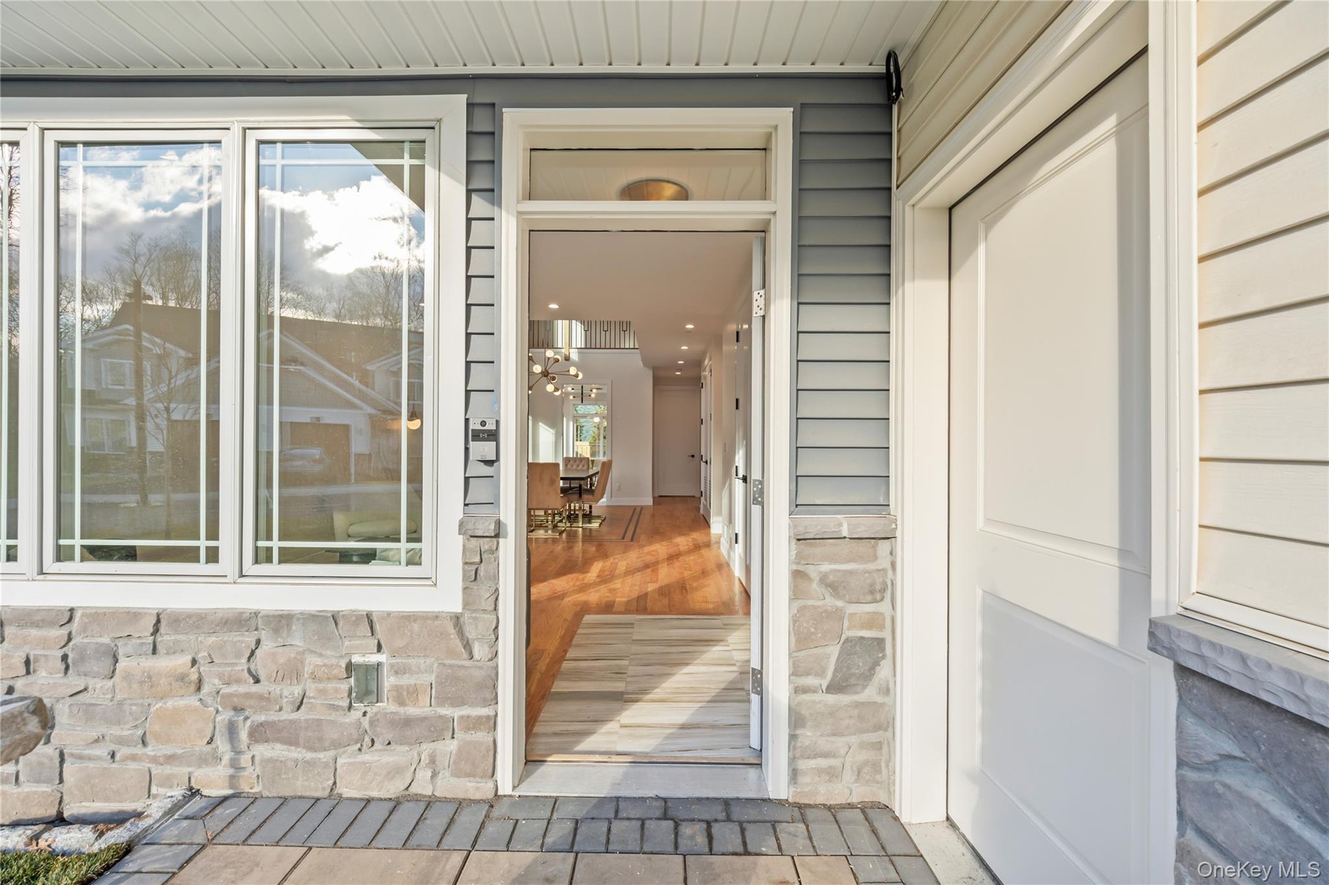 Entrance to property featuring stone siding
