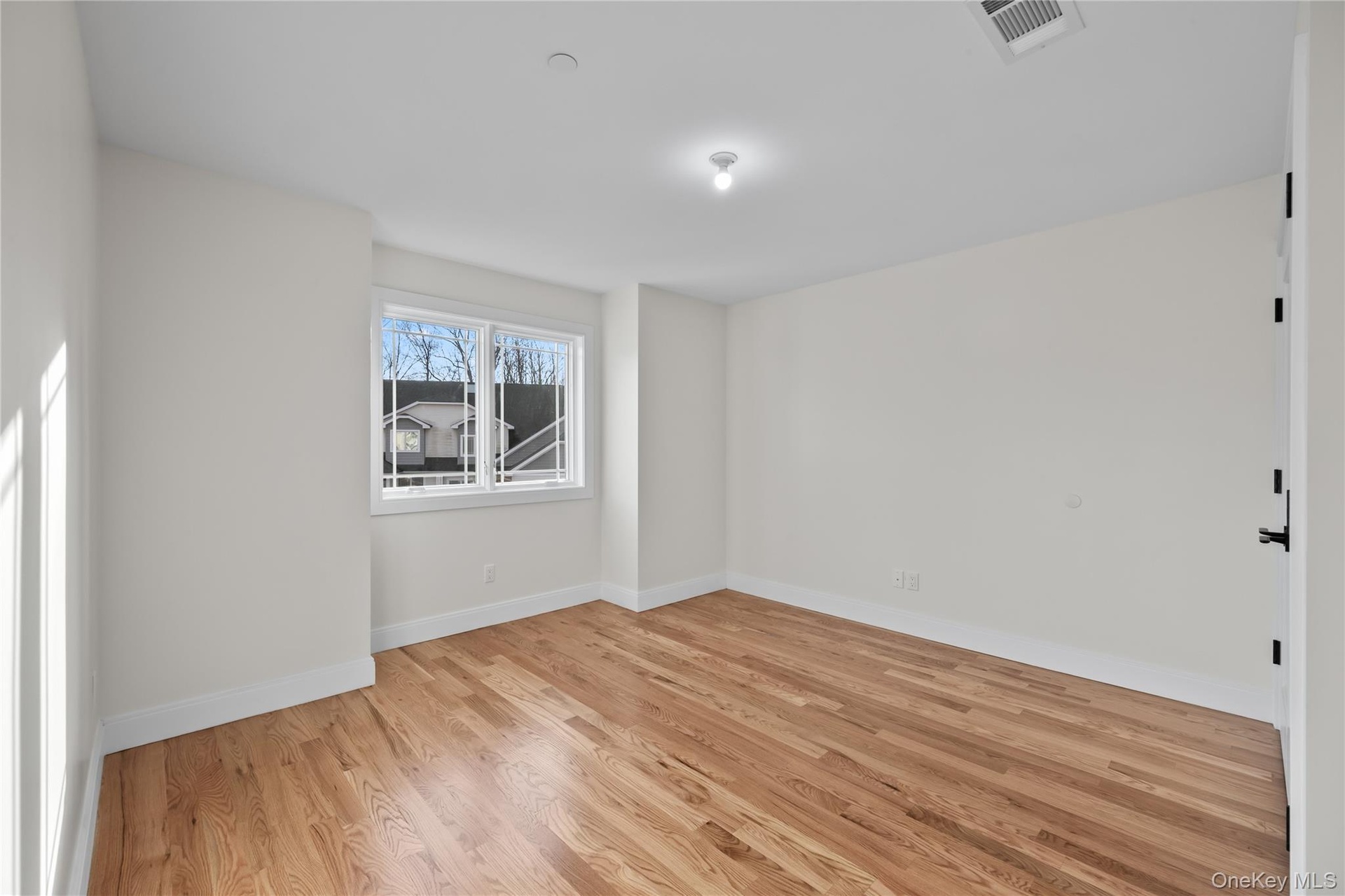 Spare room with light wood finished floors and baseboards