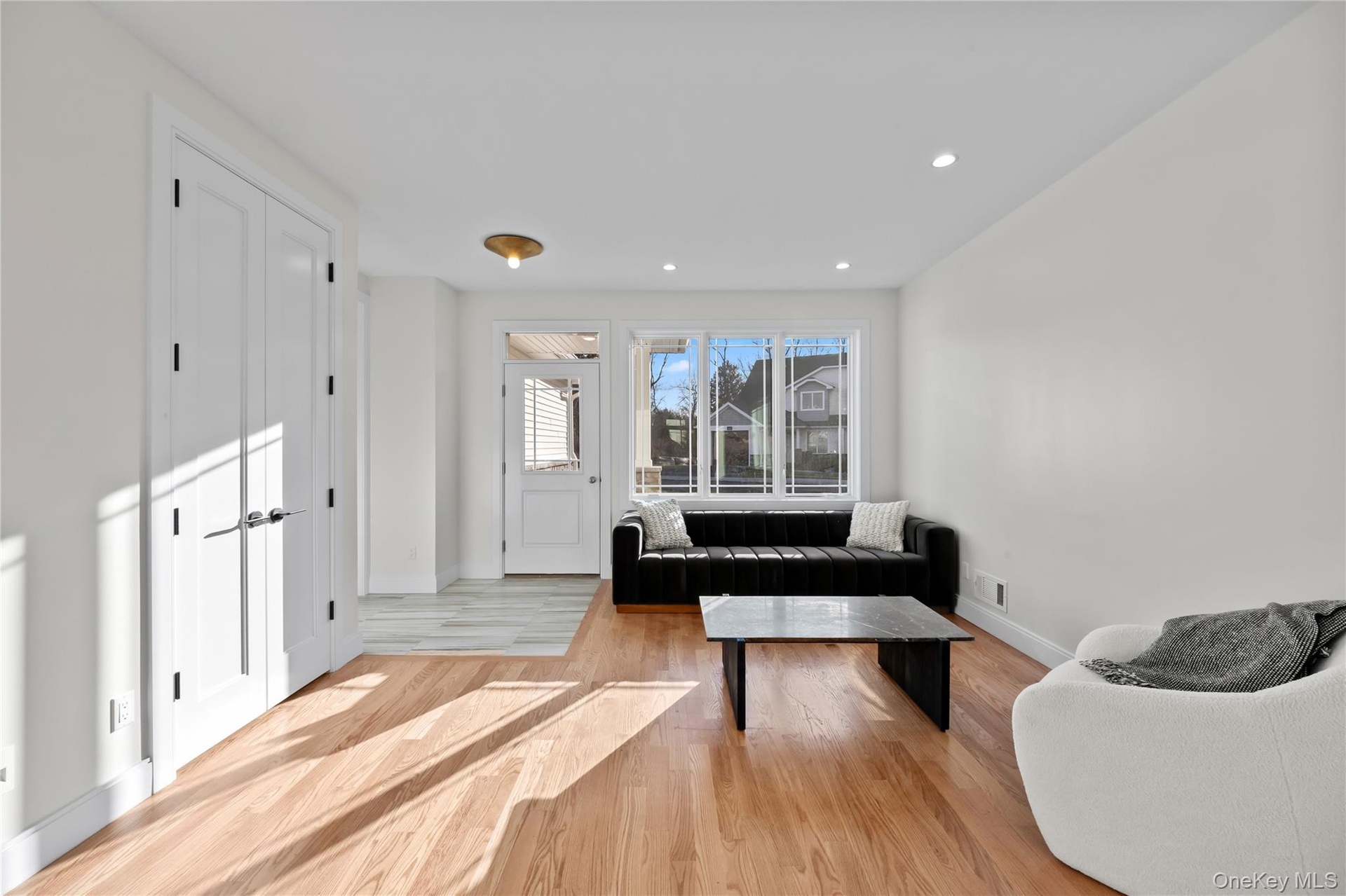 Living area featuring light wood-style flooring and recessed lighting