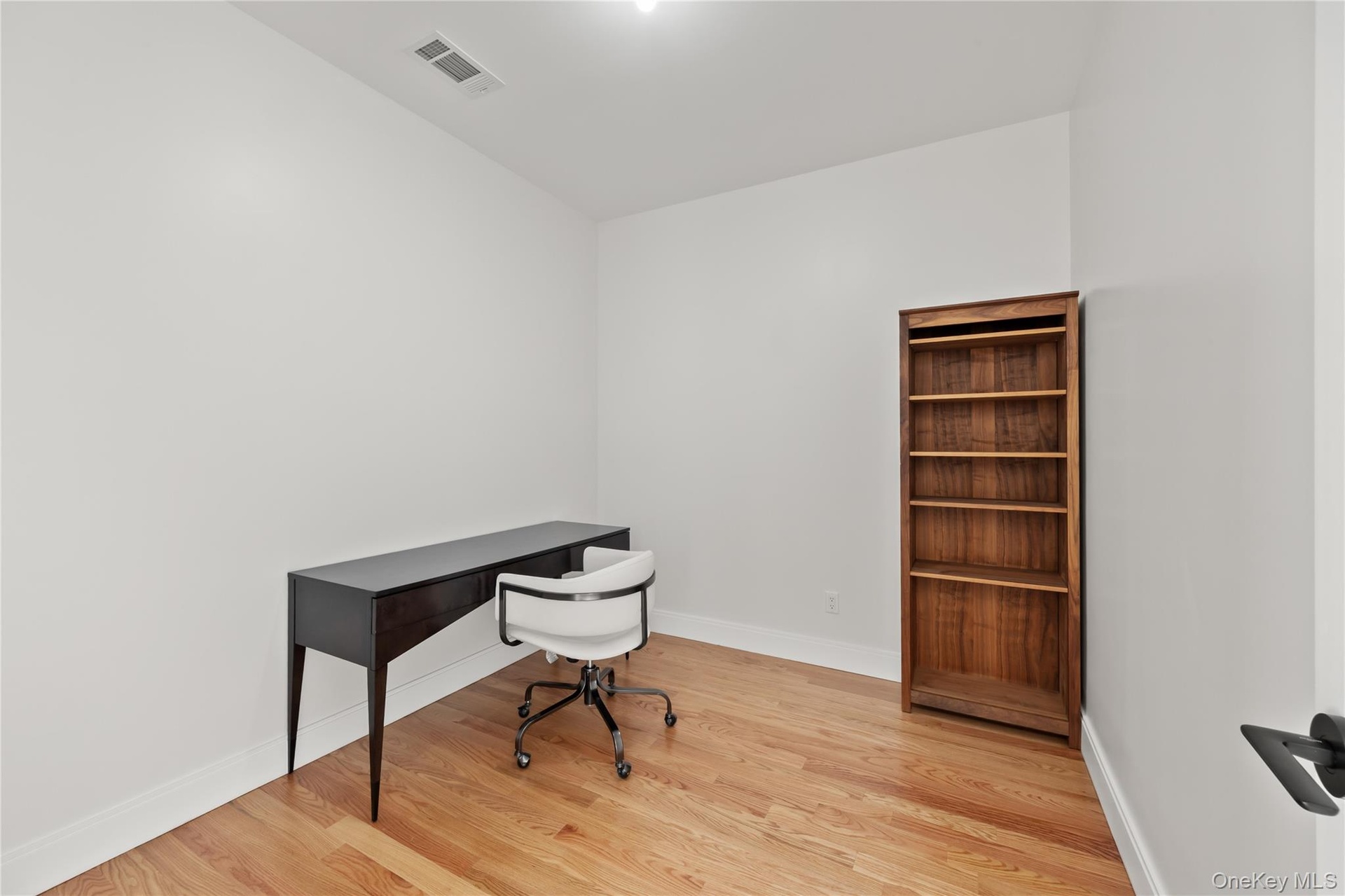 Office area featuring light wood-type flooring and baseboards
