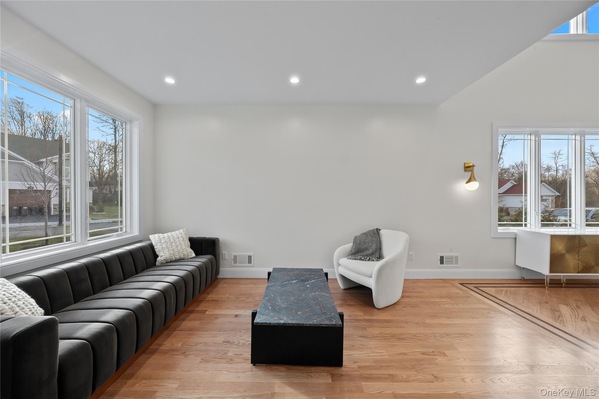Living area featuring light wood-style floors and recessed lighting