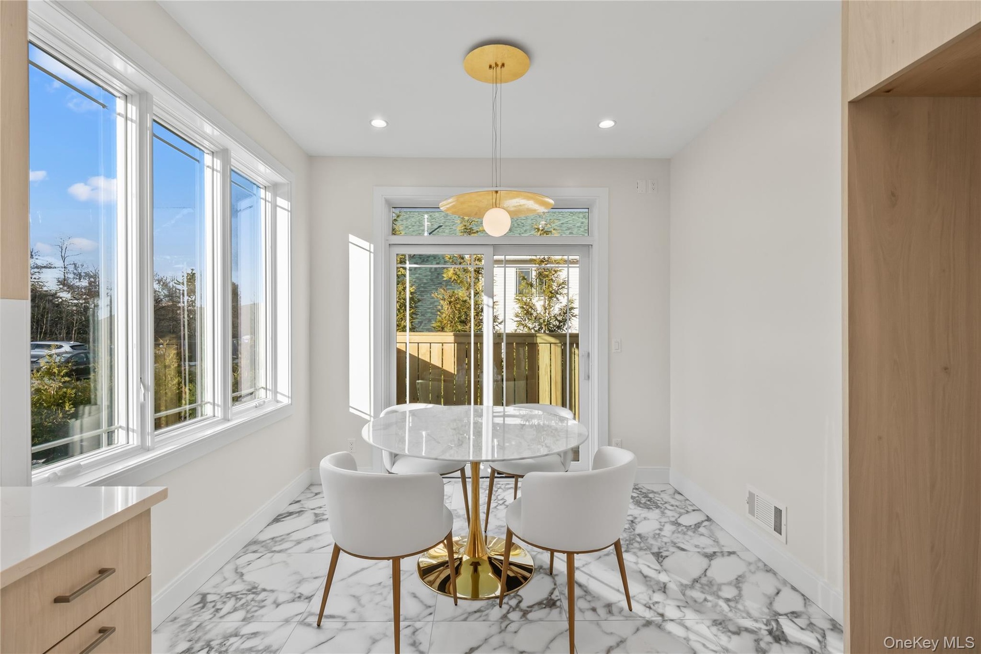 Dining area featuring light marble finish flooring, recessed lighting, and plenty of natural light