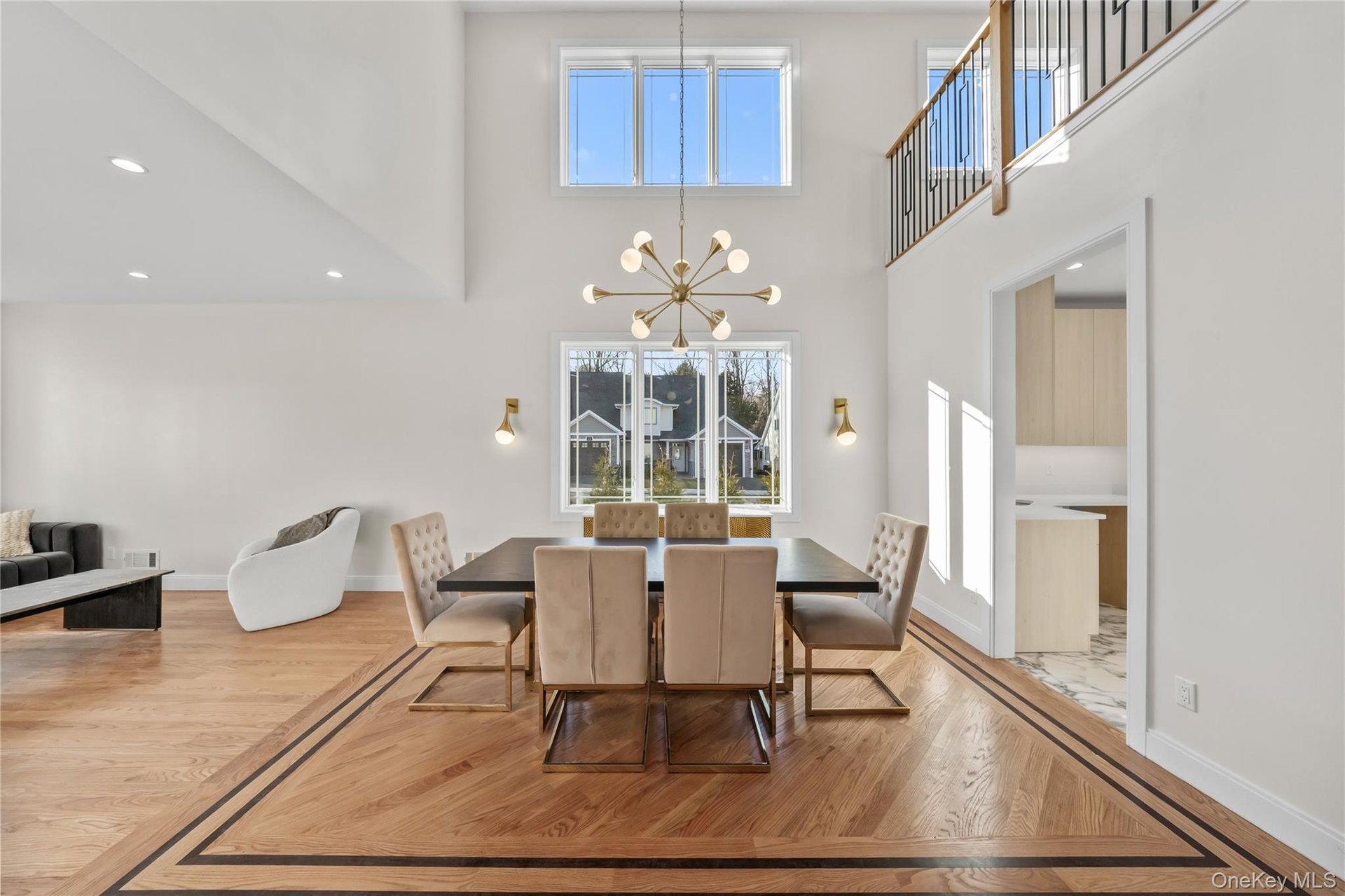 Dining room with recessed lighting, light wood-type flooring, a chandelier, and a high ceiling