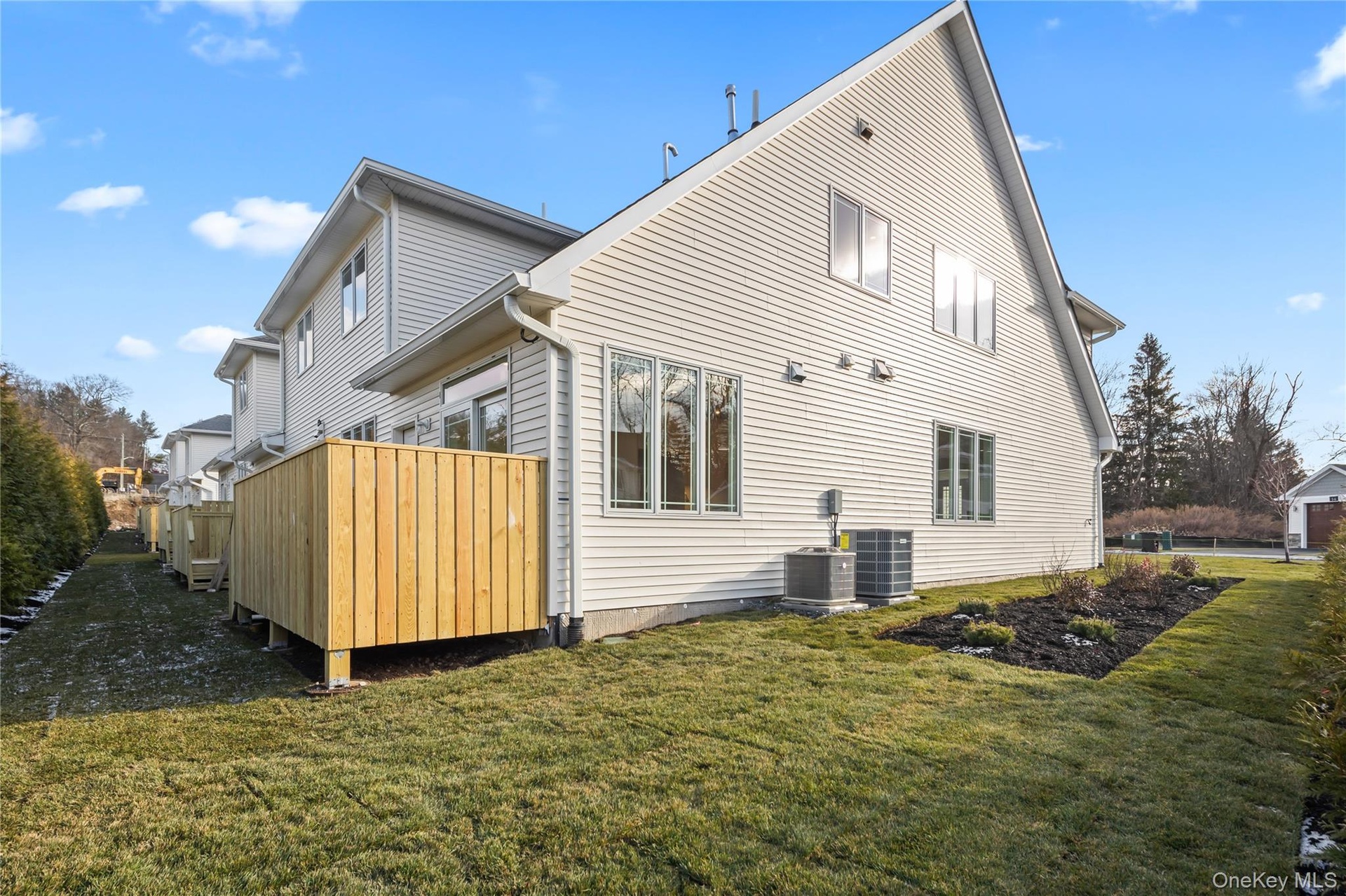 Back of house featuring a yard and a deck
