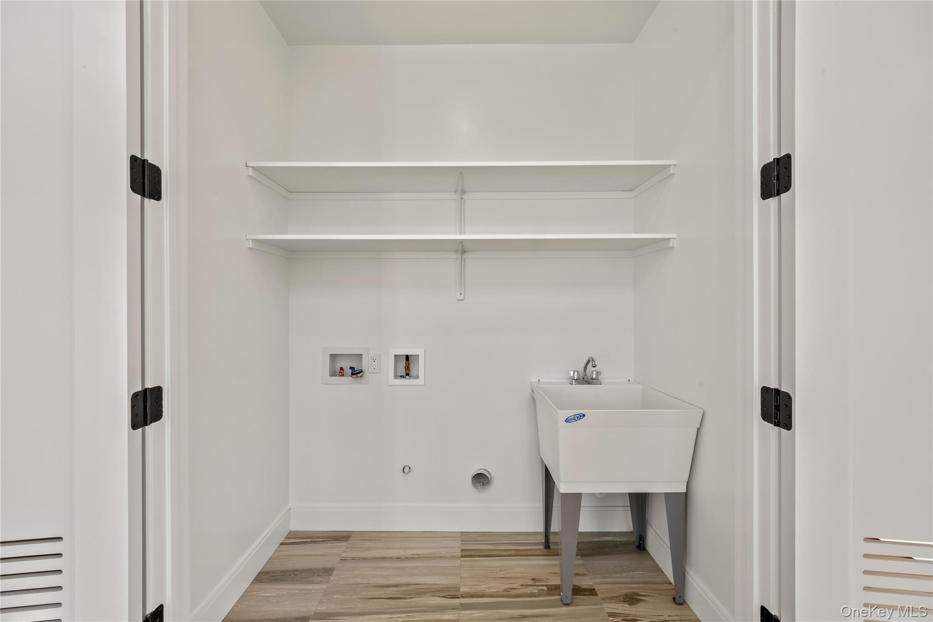 Washroom featuring washer hookup, light wood-style floors, and hookup for a gas dryer