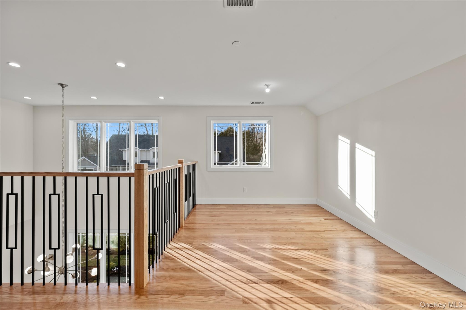 Spare room with light wood finished floors and recessed lighting