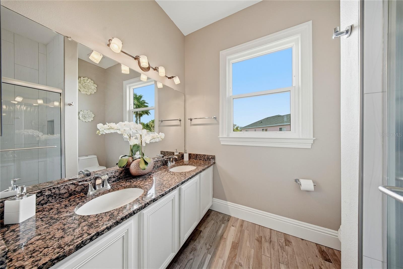 This dual sink bathroom is spacious and is between the second and third bedroom