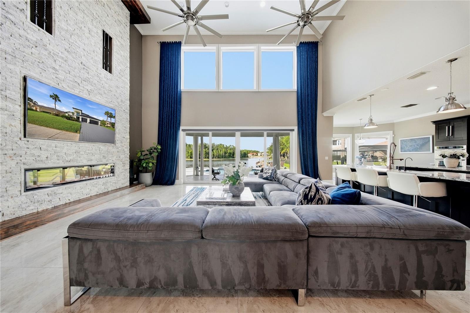 The family room has stunning lake views with an electric fireplace with built in 85 TV