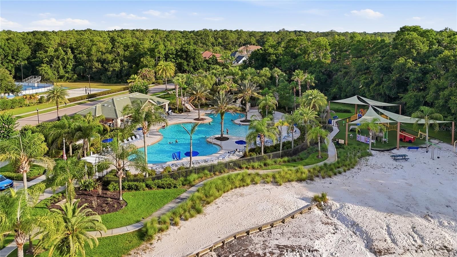 Cory Lake Isles Beach club with resort style lagoon pool, water slide and zero entry (beach-style) pool  access and playground