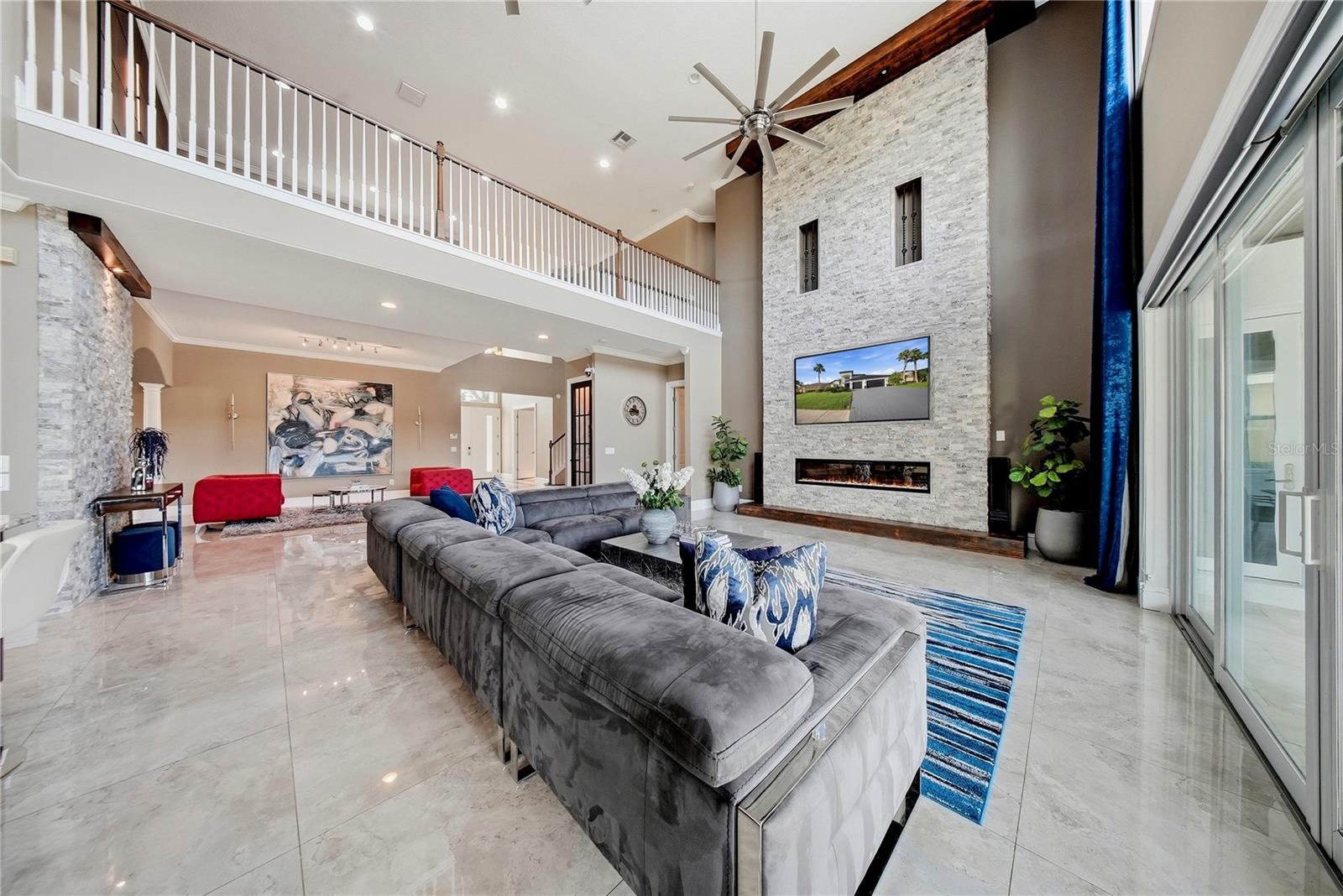 Soaring ceilings give this main living space a bright, open and airy ambiance