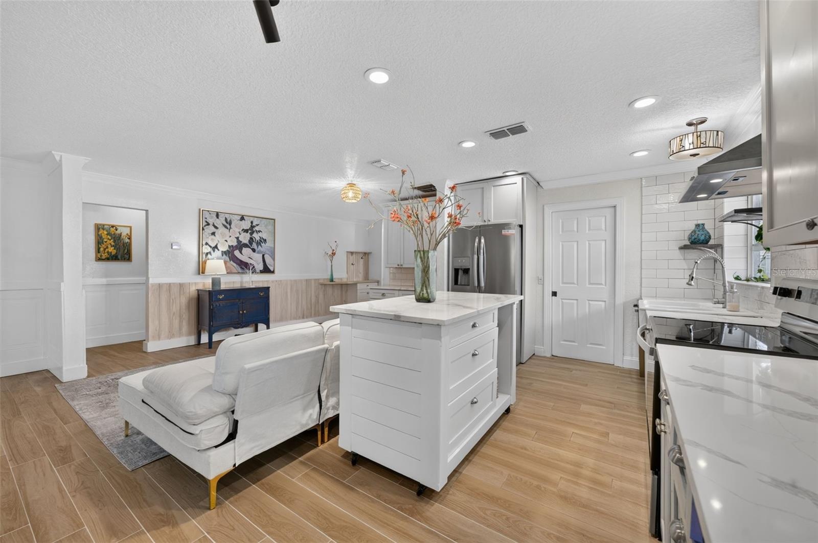 Kitchen opens to one of two living areas