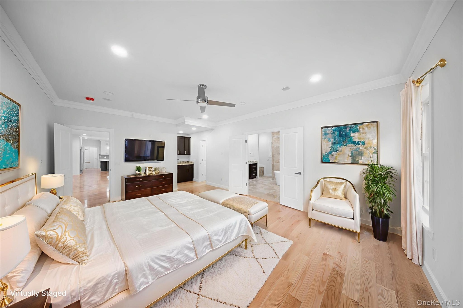 Bedroom featuring ornamental molding, light wood-style floors, recessed lighting, ensuite bath, and a ceiling fan