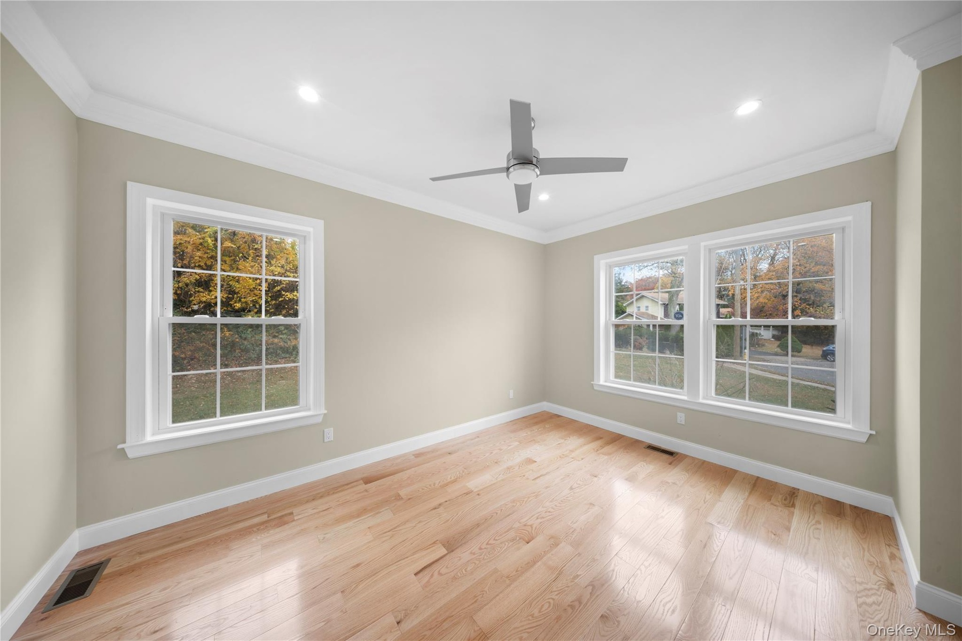 Spare room with ornamental molding, light wood finished floors, recessed lighting, and a ceiling fan