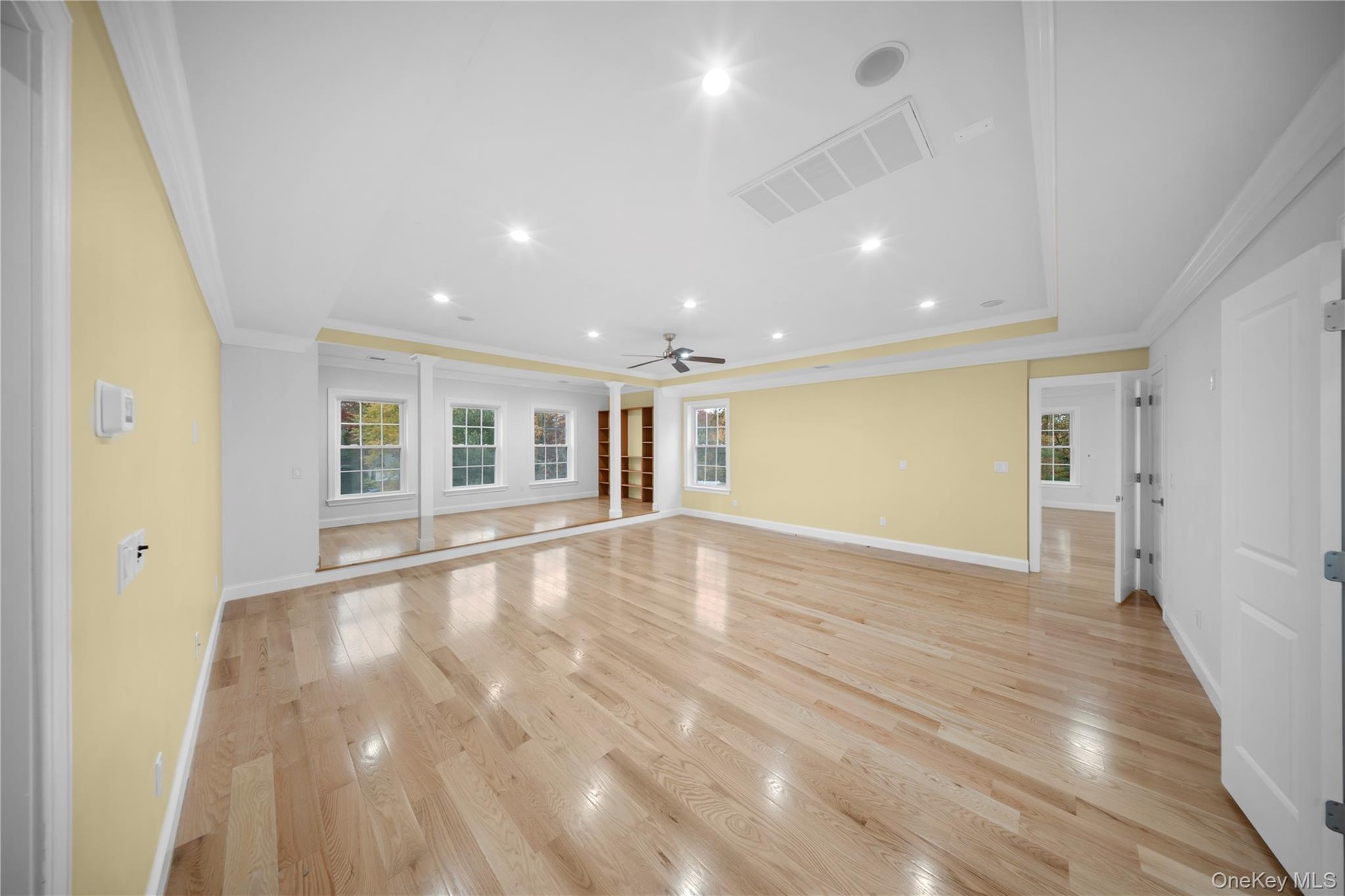 Unfurnished living room with recessed lighting, light wood finished floors, crown molding, and ceiling fan