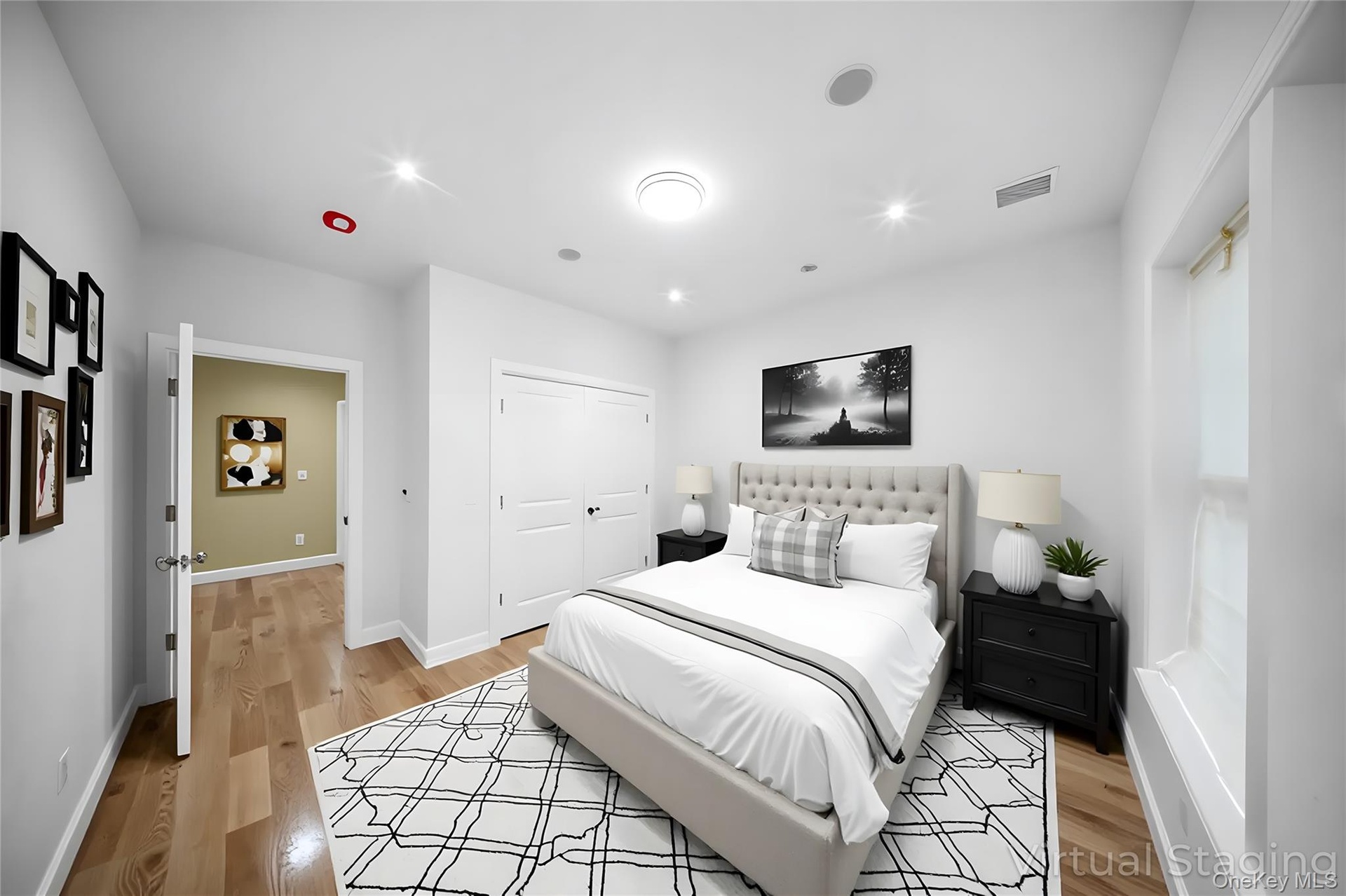 Bedroom with light wood-style flooring, recessed lighting, and a closet